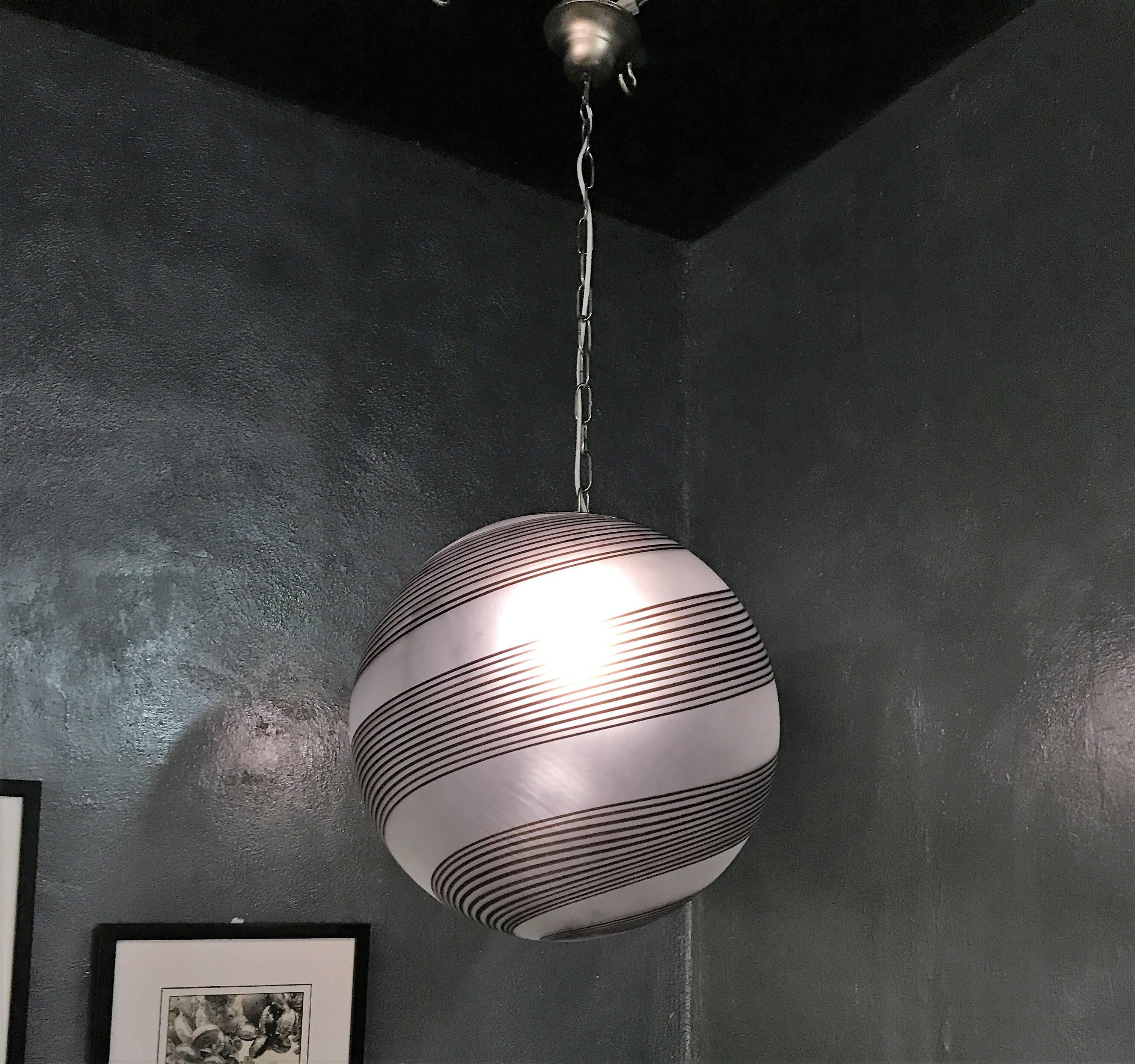 Beautiful and large pendant light in clear frosted with black stripes handblown Murano glass, attributed to Venini, circa 1970.
