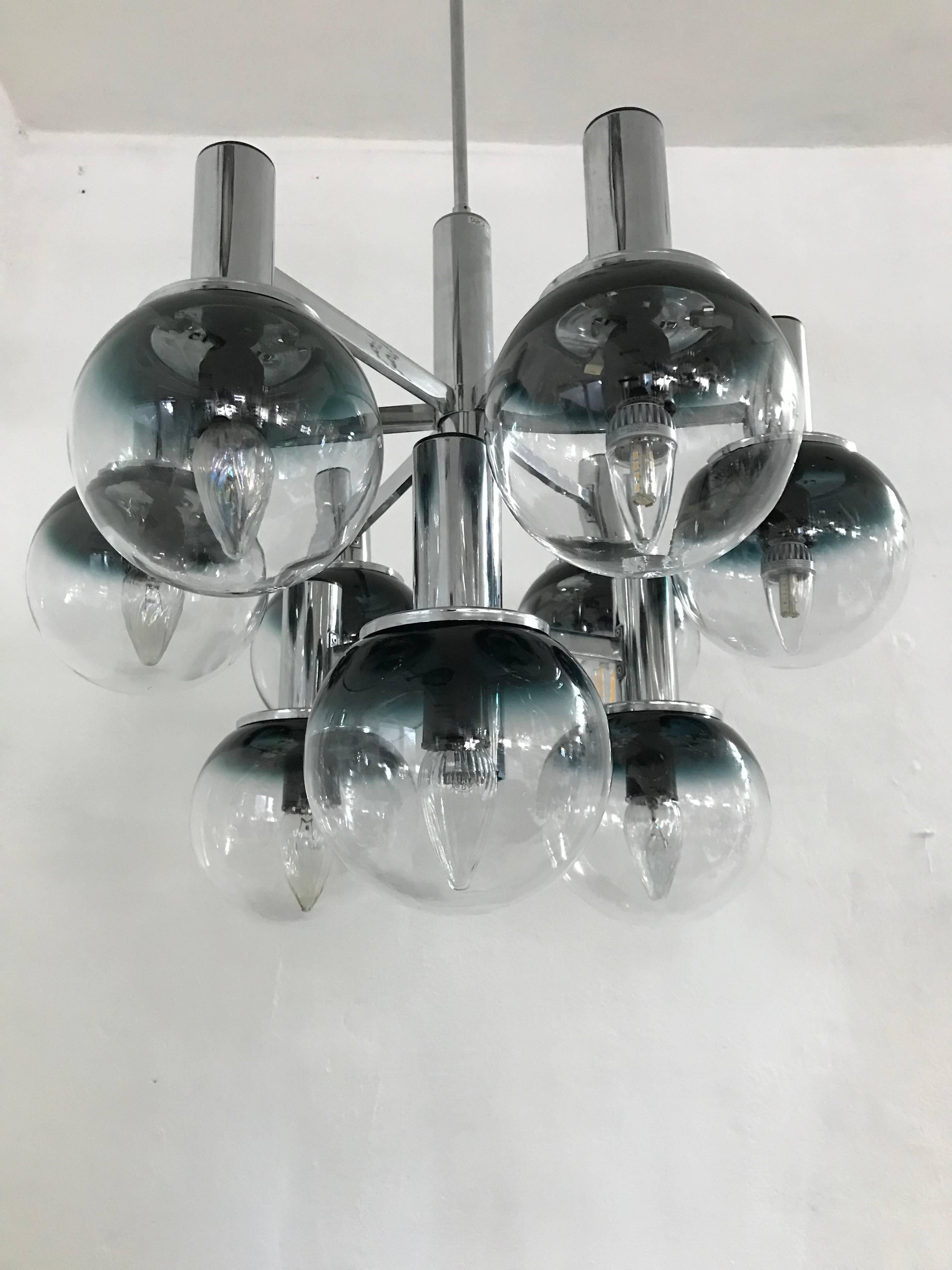 Beautiful 9 light,  Space age chandelier by Targetti Sankey  in chromed metal and Murano clear and smoked (blue) glass.
Retains original sticker.
The diameter of the globes is 19 cm.
