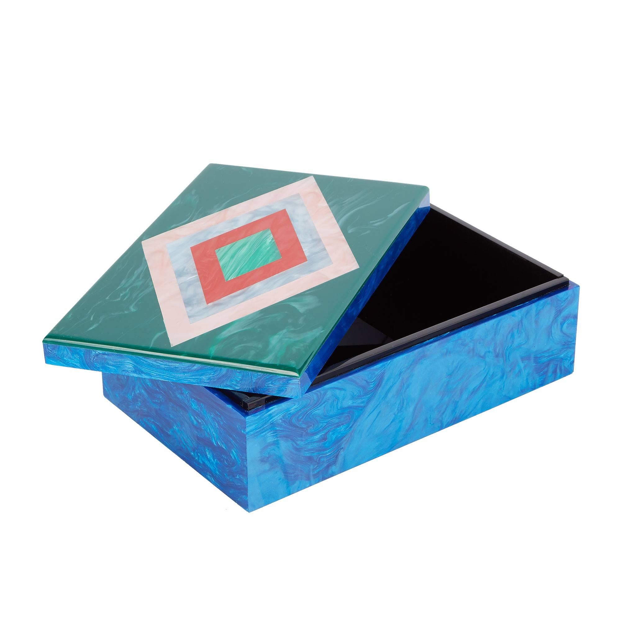 Diamond box with ocean pearlescent base and malachite lid with diamond motif in pink, blue, red pearlescent and kelly green. 

100% hand poured acrylic
Etched logo at base

Edie Parker products are handcrafted of the finest materials by skilled