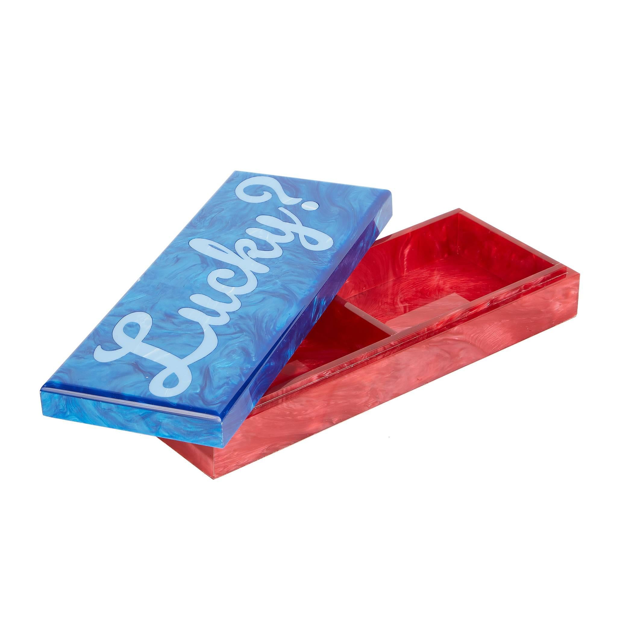 Card box lucky with red pearlescent base and ocean blue lid with light blue script text. 

100% hand poured acrylic
Etched logo at base

Edie Parker products are handcrafted of the finest materials by skilled artisans. Any inconsistencies in
