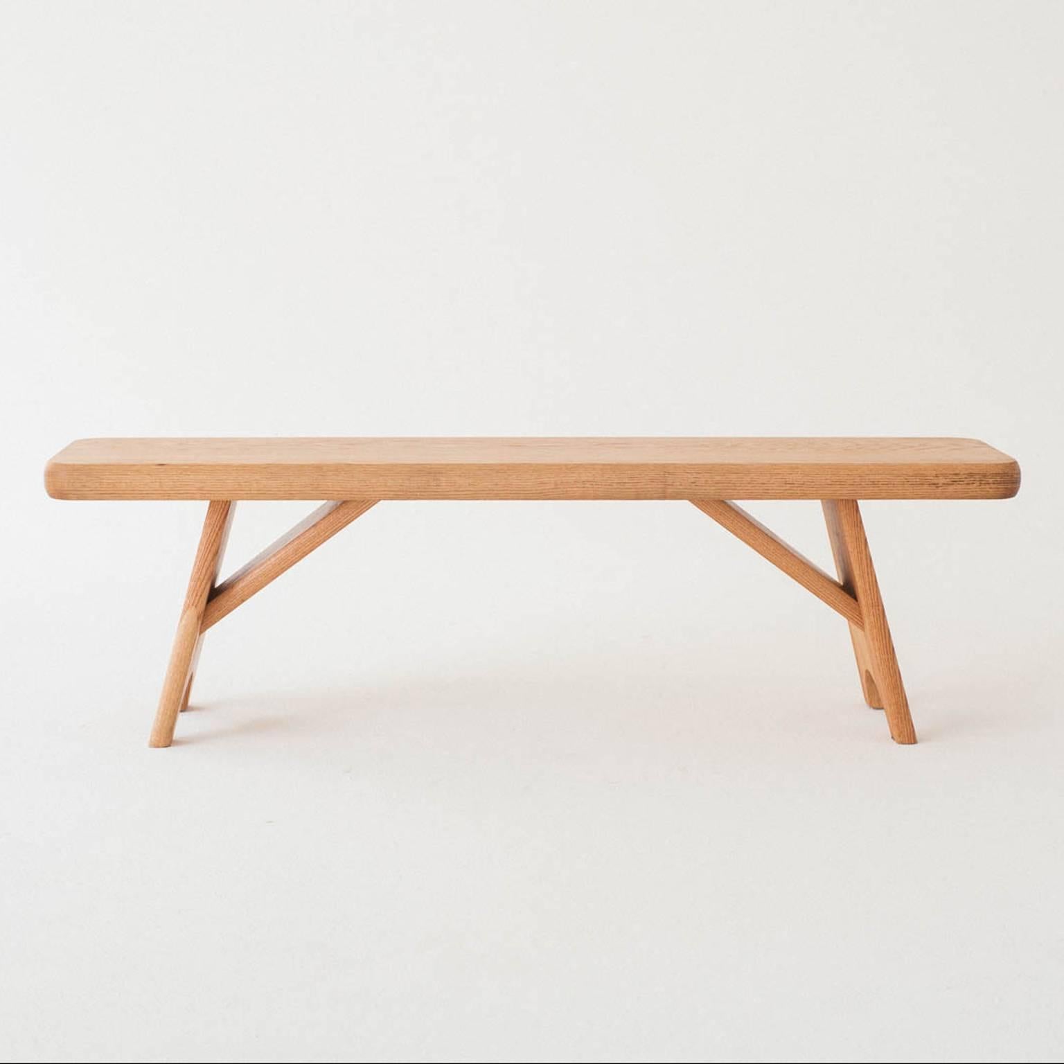 A sturdy and balanced bench that completes any room. Echoing the lines of a simple Shaker bench in minimalism and simplicity the Merton bench, like its namesake, holds a decidedly simple and refined presence. Angled legs provide poise and stability.