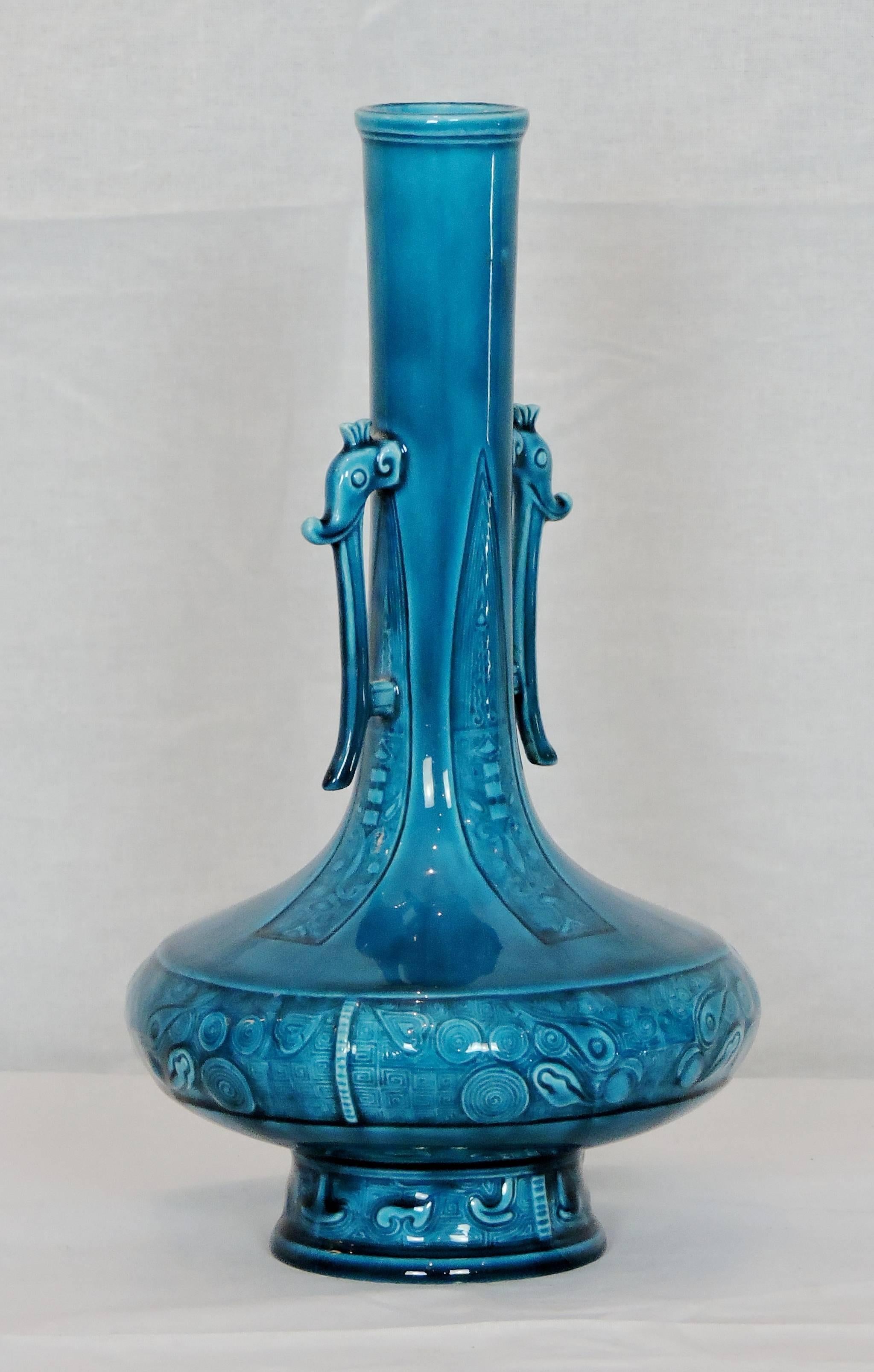 This rare soliflore vase is decorated in the oriental style: the base moulded with oriental floral motives, the neck adorned with two symmetrical elephant heads. 

A fine example of Theodore Deck's creation and 19th century European trends,