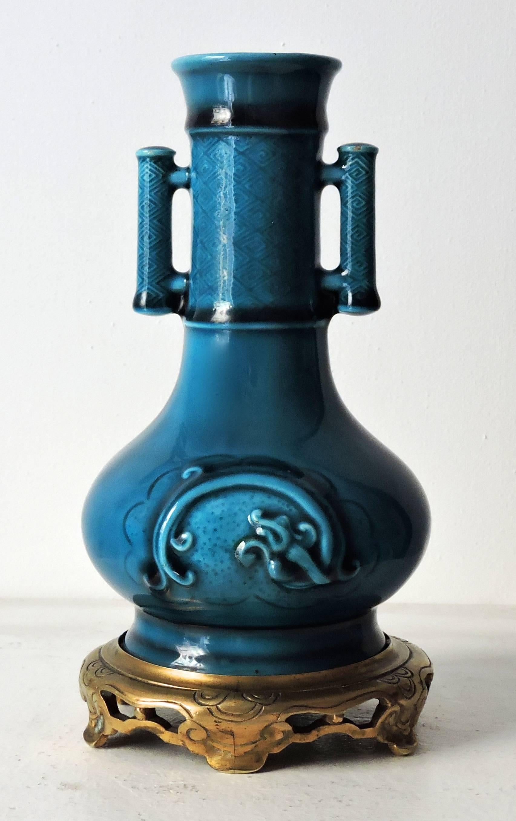 A Théodore deck faience blue Persian baluster vase with ormolu gilt mount, molded in the Chinese archaistic taste, the body with stylized dragons, the neck with losanges pattern and two symmetrical handles.
Impressed TH.DECK Mark.