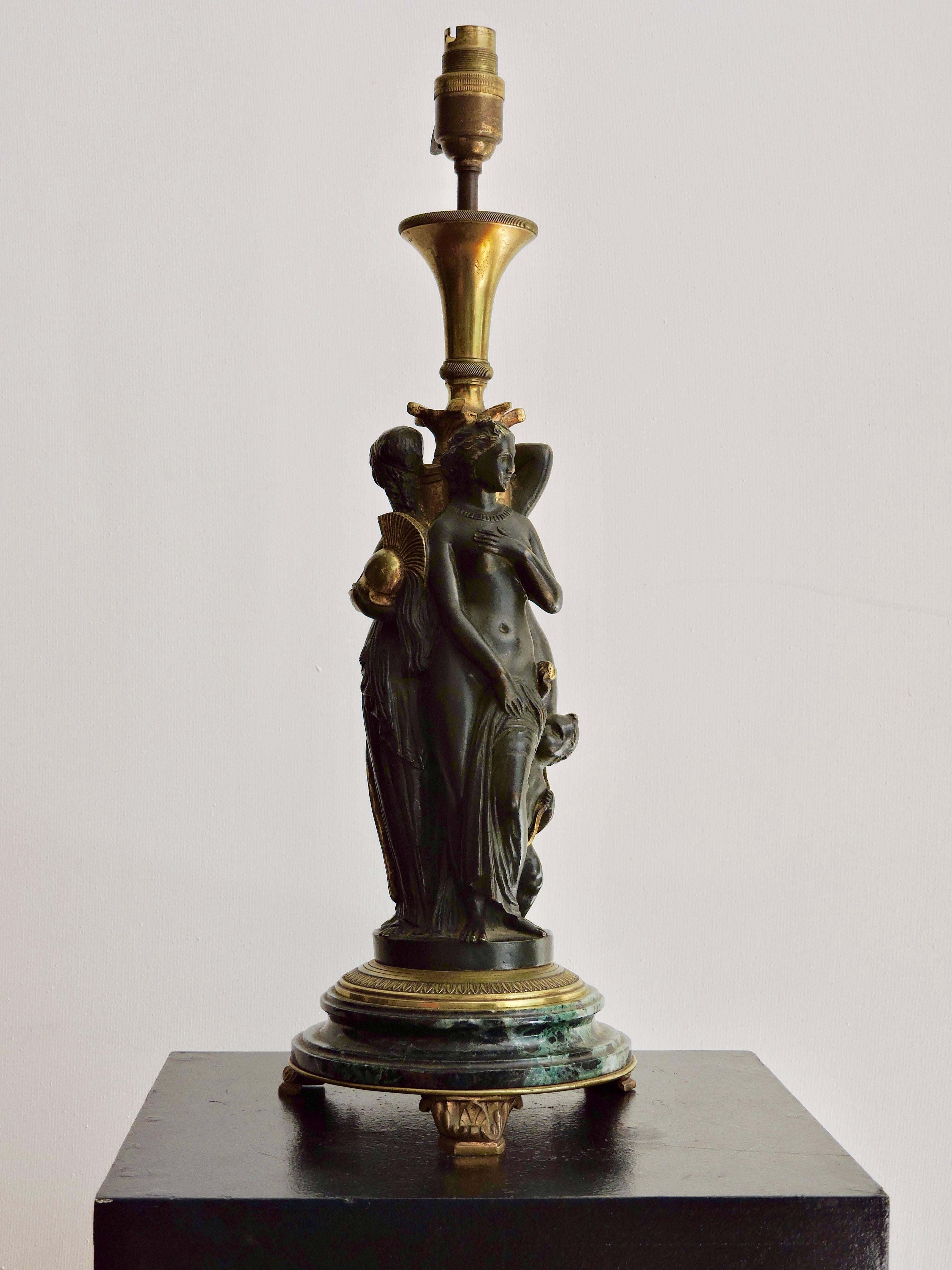 A Napoléon III patinated bronze and ormolu lamp three graces designed on a green marble base, signed A.Marrionet Bronzes Paris under the base
Total height with light fitting 49 cm.