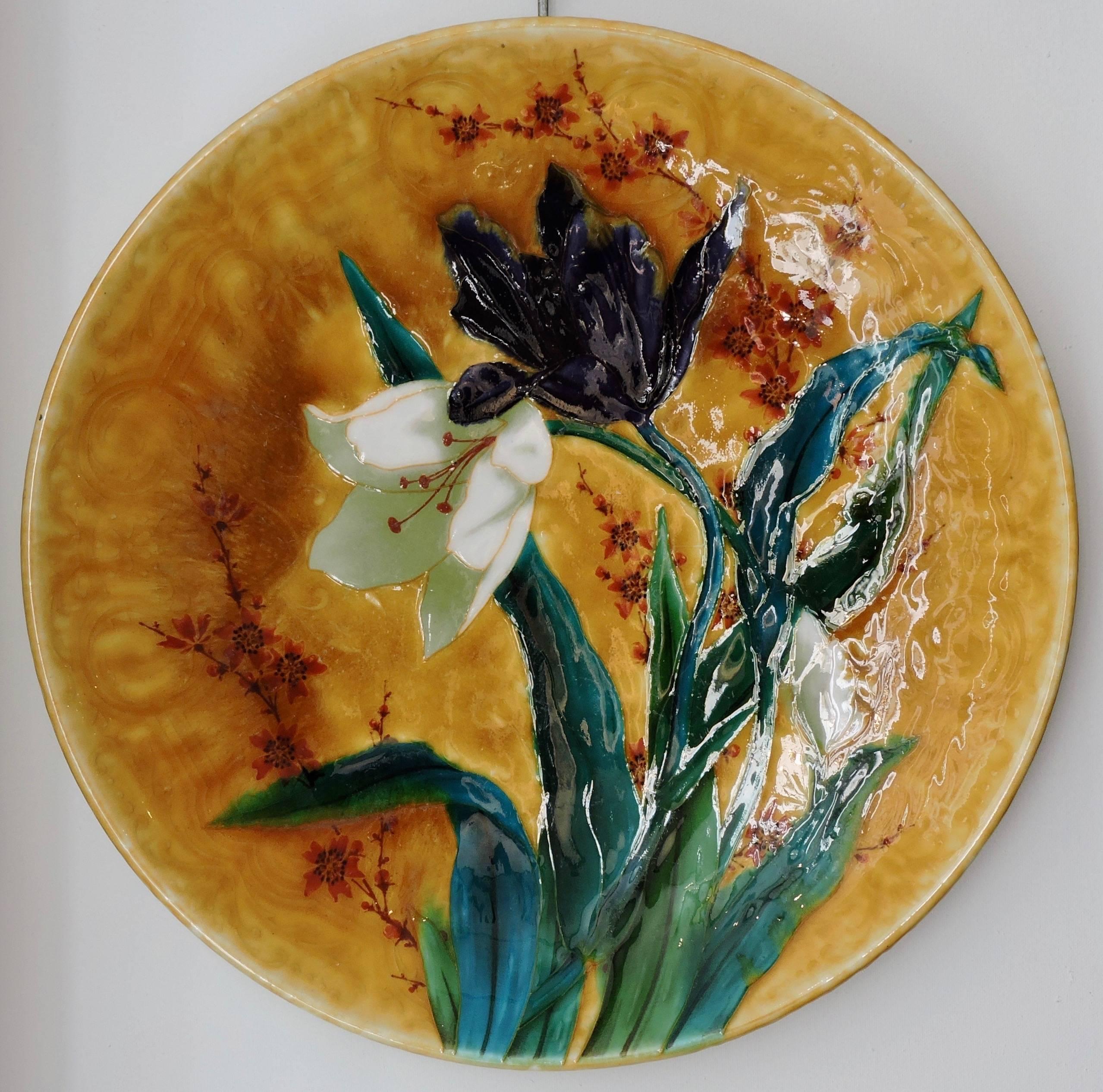 A Large Théodore deck circular enamelled faience platter with polychrome design of tulips on a yellow background.
Signed with TH. Deck and profile stamps
circa 1880-1890.