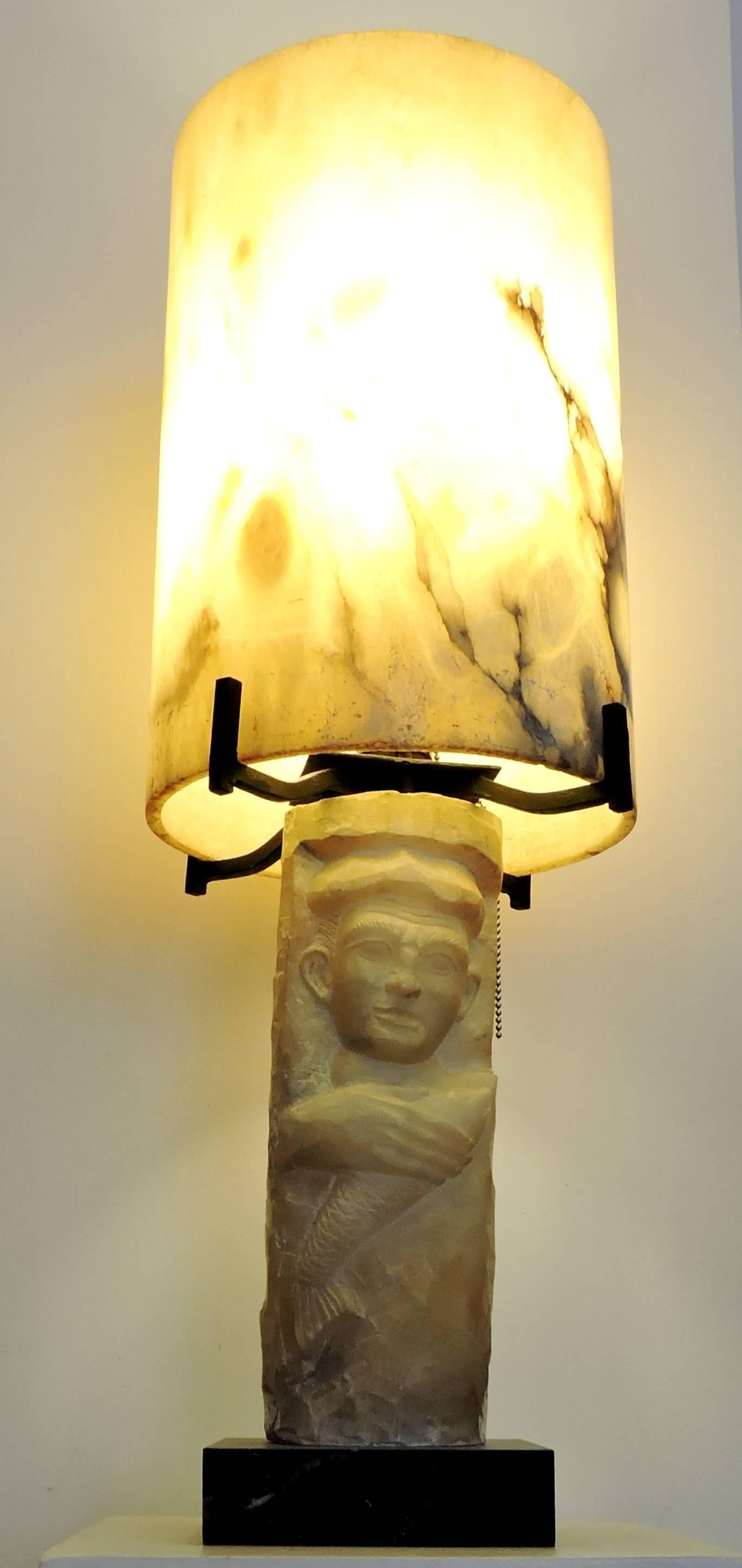An 1940s alabaster wrought iron mounted lamp and black marble square base with fisherman design.