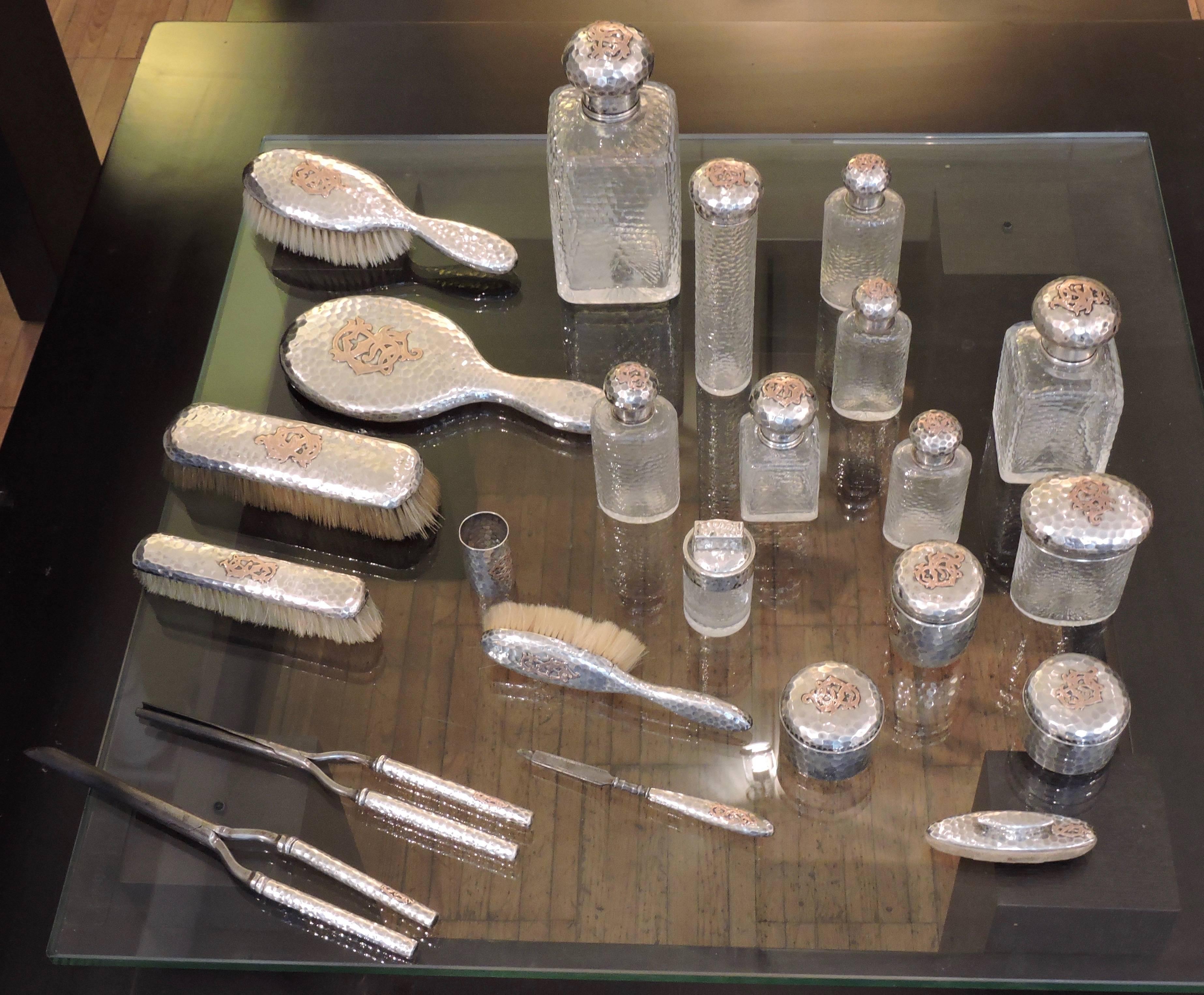 A circa 1930 mixed metal French toilet set, Monogrammed C.S in copper, glass and metal Martelé composed of 23 pieces.
Each piece Stamped EG and with French Maker's Mark E.G with a flag
Perfume bottles of different dimensions.
  