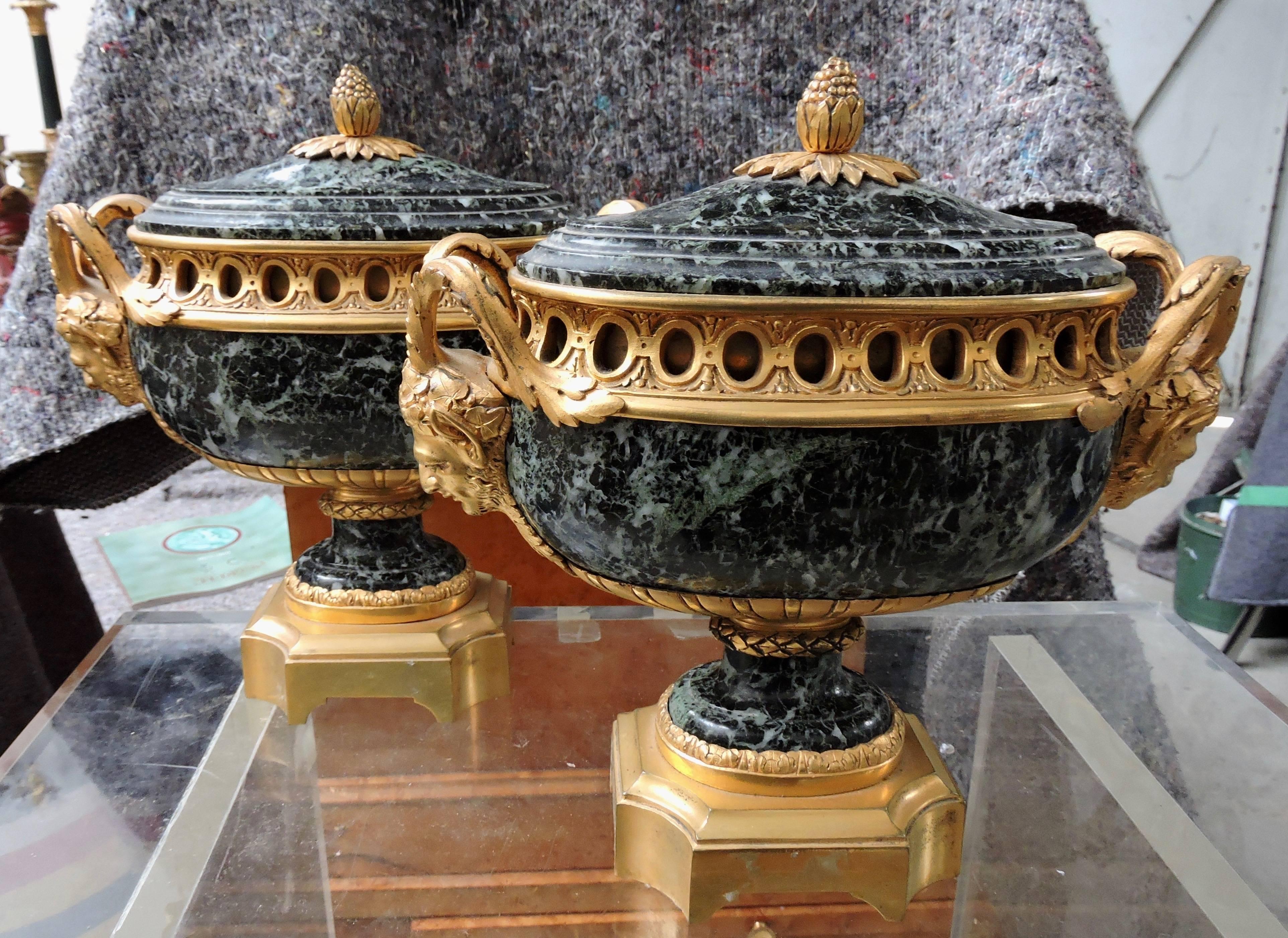 Pair of Louis XVI style breccia green marble and ormolu-mounted oval-shaped navettes, circa 1870
Ormolu designed with faun's heads, the covers with pinecone, on an octagonal base.

       