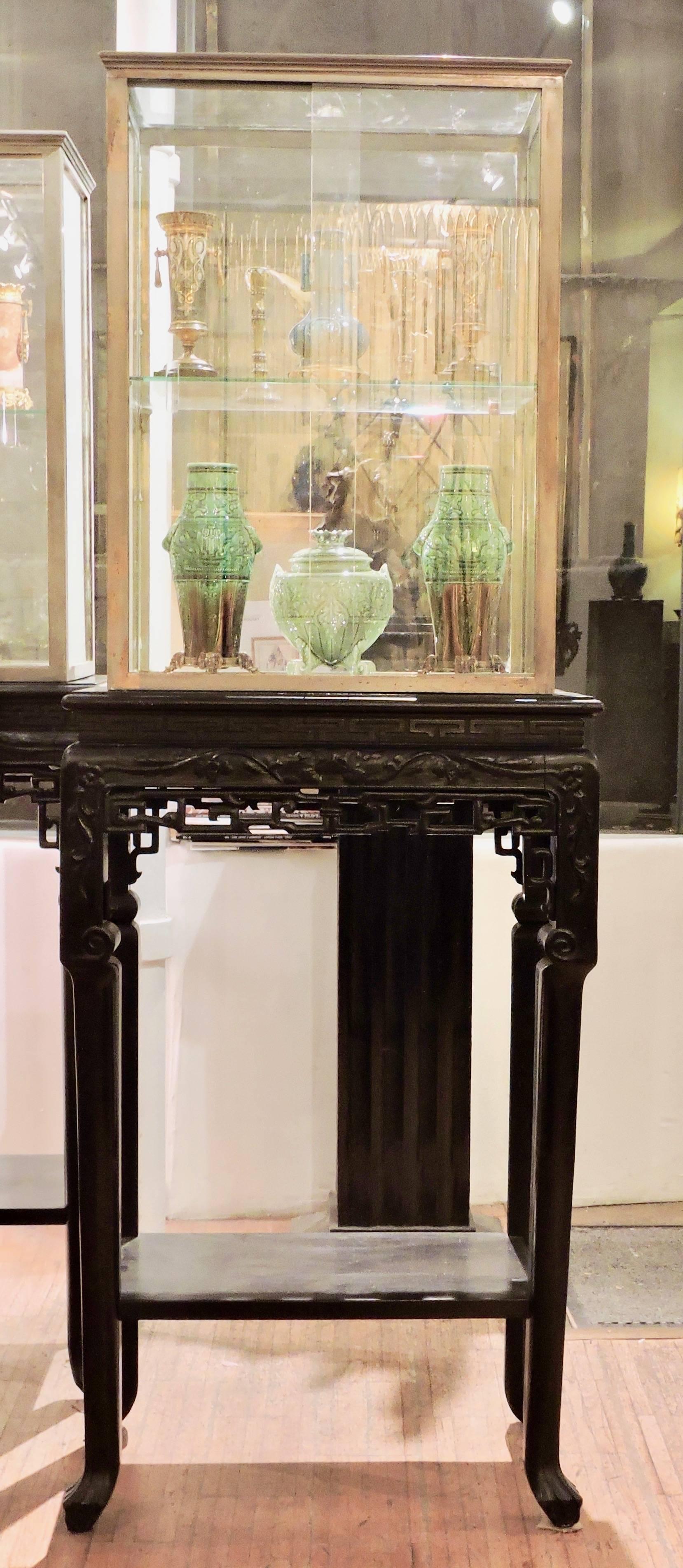 A 19th century Japonisme pair of vitrines on wood stand
each composed of silvered bronze and glass vitrines with glass and mirror shelves
the stands in black wood designed in the Japonisme taste.