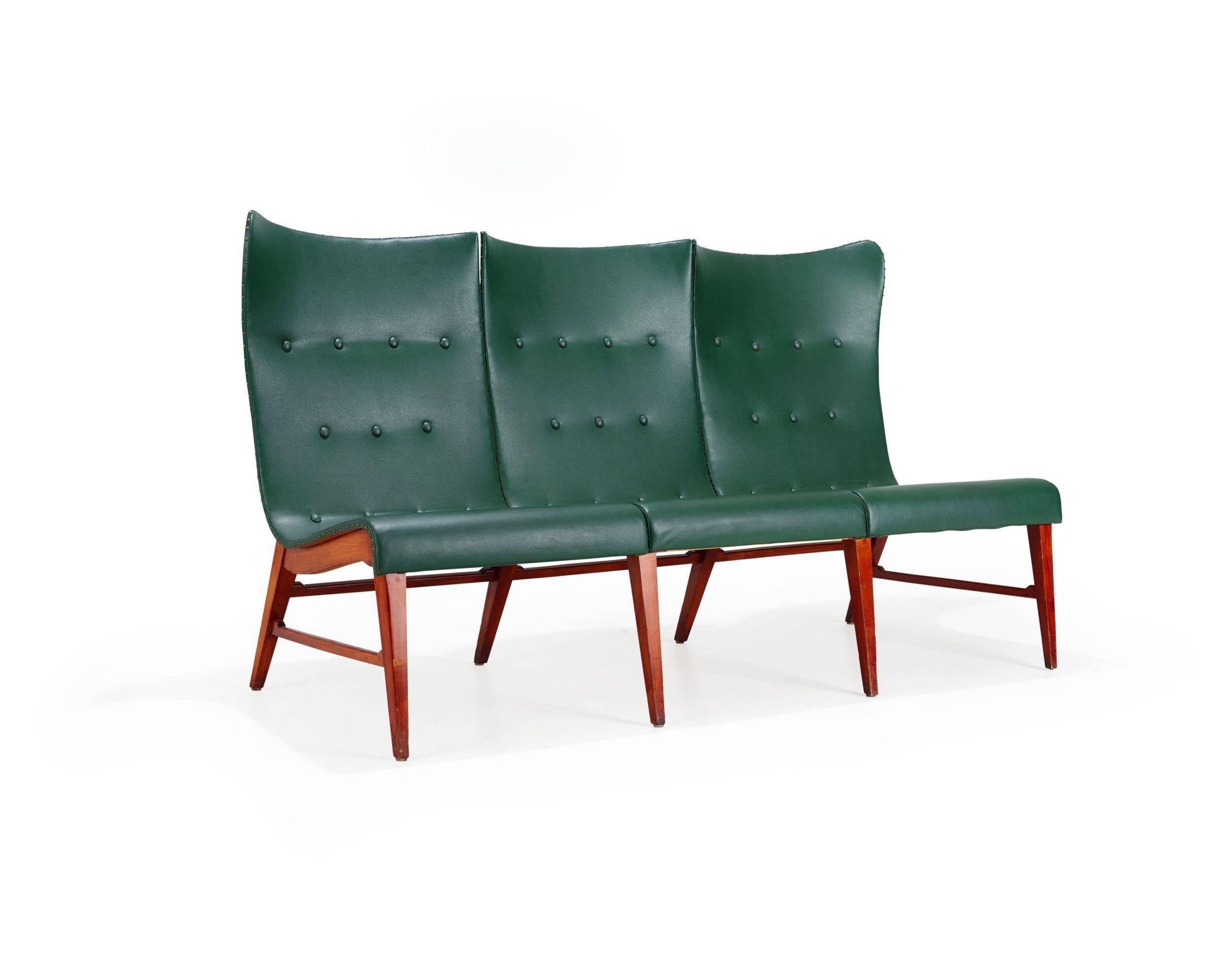 Paneled Mid-Century Modern wingback sofa by Axel Larsson, circa 1950 for Bodafors. Back panels and base in mahogany. Covered in original aqua leather with. In original vintage condition with some slight staining on leather.