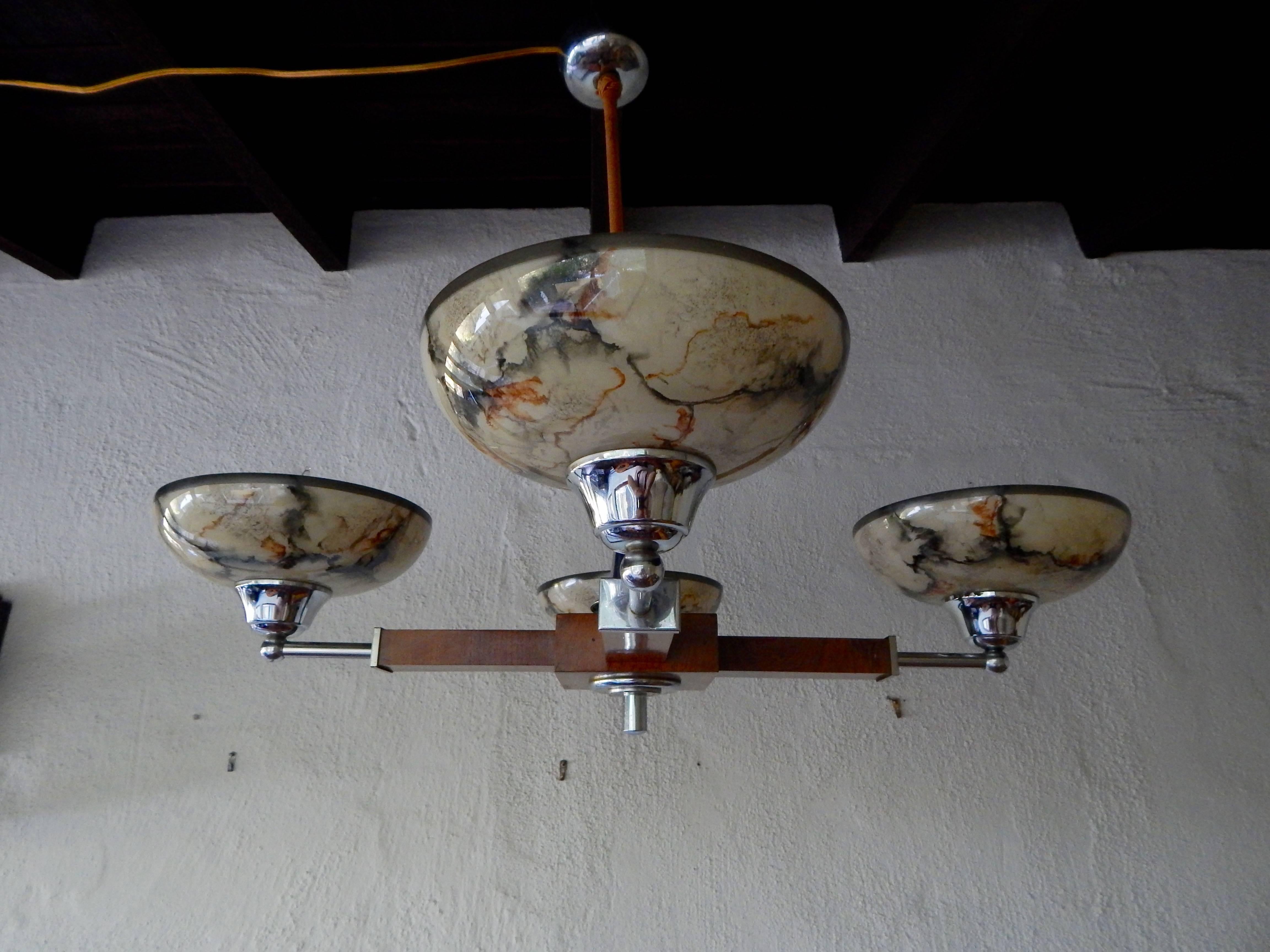 Swedish Mid-Century Modern four-arm hanging fixture in wood, chrome and glass ca 1950. Freshly re-wired for use in the USA. Shades in marbleized glass. Contact us with any questions.