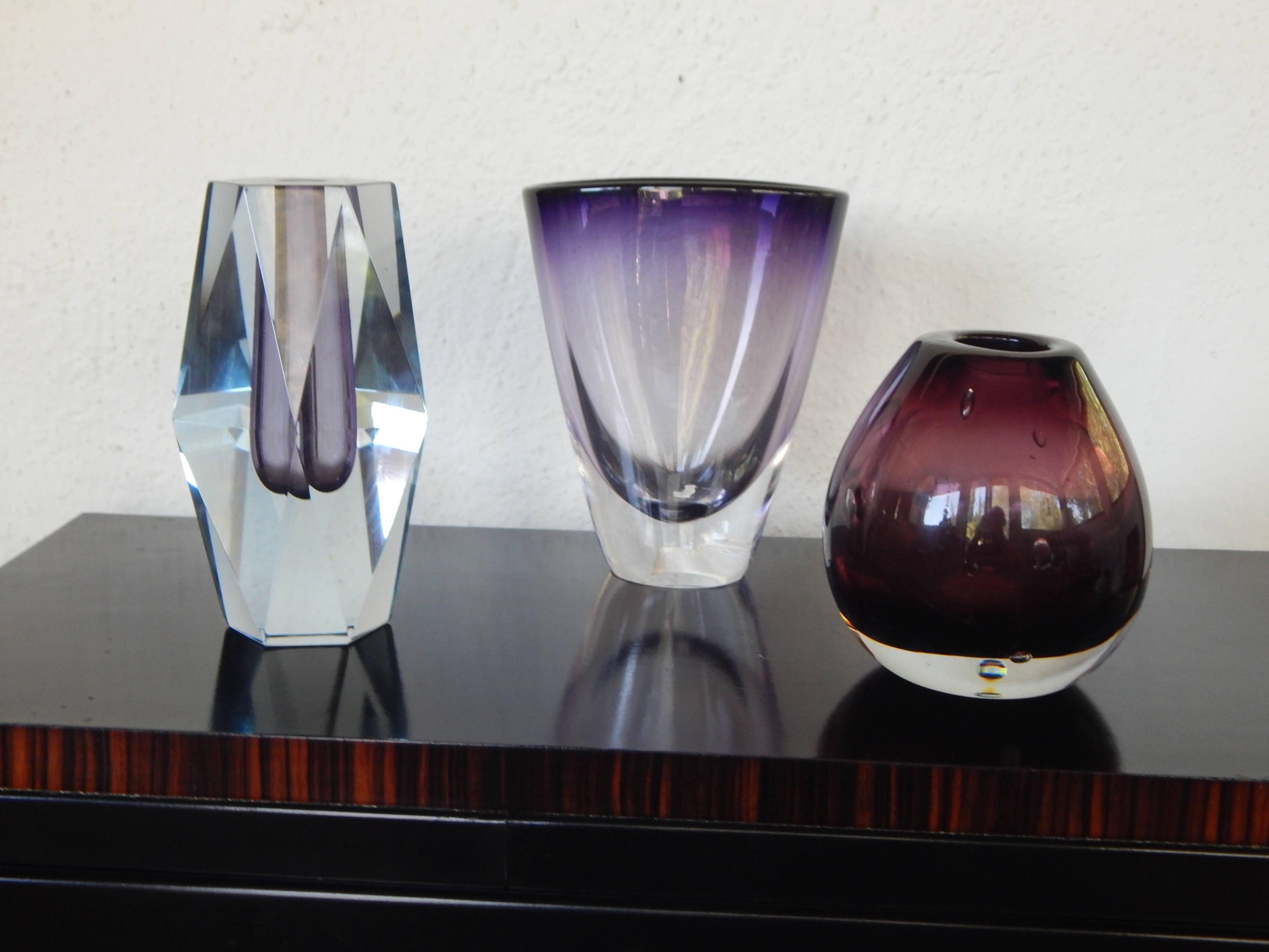 Three Swedish Mid-Century Modern blown and cast glass vases. In clear with blue and purple color accents. In excellent vintage condition with a couple of very superficial abrasions. Please contact us for more complete dimensions. Size listed is for