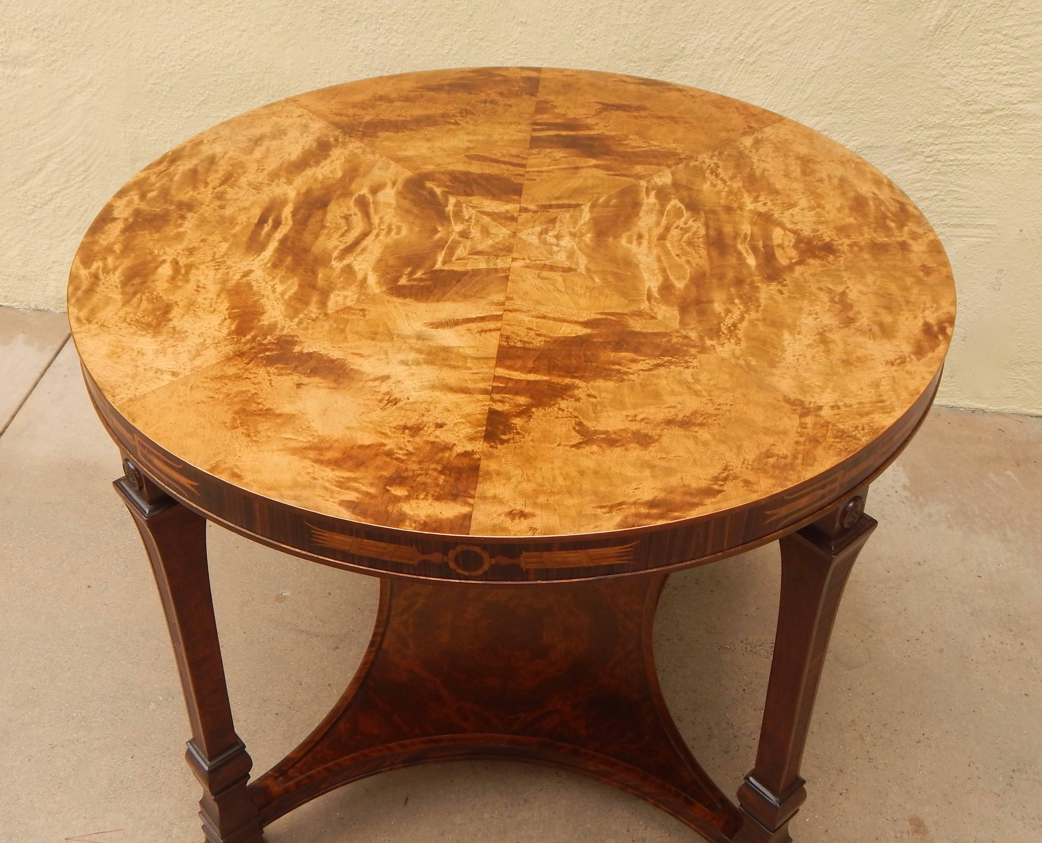 Swedish Grace (neo-classically inspired Art Deco) inlaid centre/side table rendered in birch with rosewood elm and ebony inlay. Top in highly figured, bookmatched golden flame birch wood. The piece has been sensitively restored by my woodworkers.