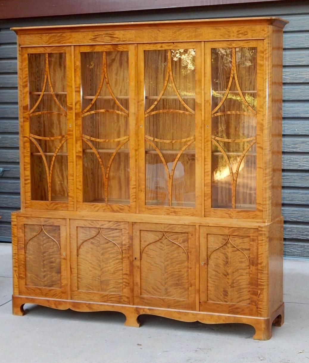 Swedish Art Deco-Renaissance Revival storage cabinet, bookcase, china cabinet. Rendered in highly figured golden flame birch wood. In excellent original condition with light wear. All original glass. All original shelves, Sweden, 1920s.