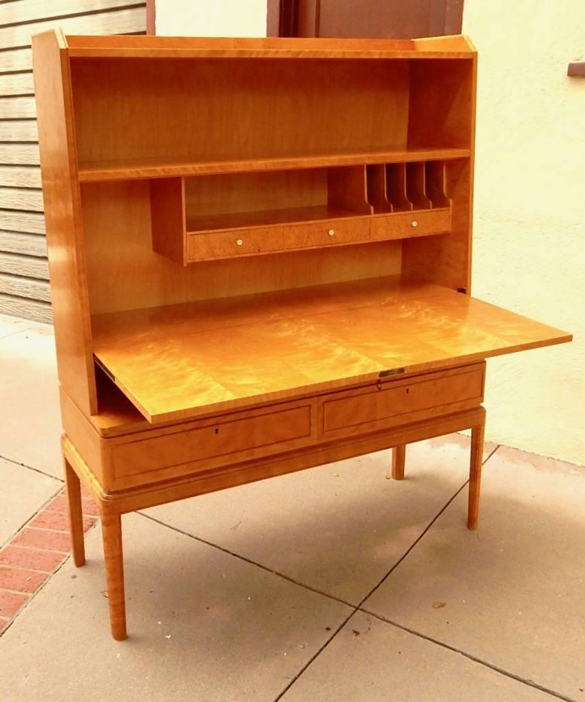 Swedish Art Moderne dry bar- desk in golden flame birch, circa 1940. Rendered in highly figured, bookmatched birch. Interior composed of birch and Karelian birch. See photos for details.