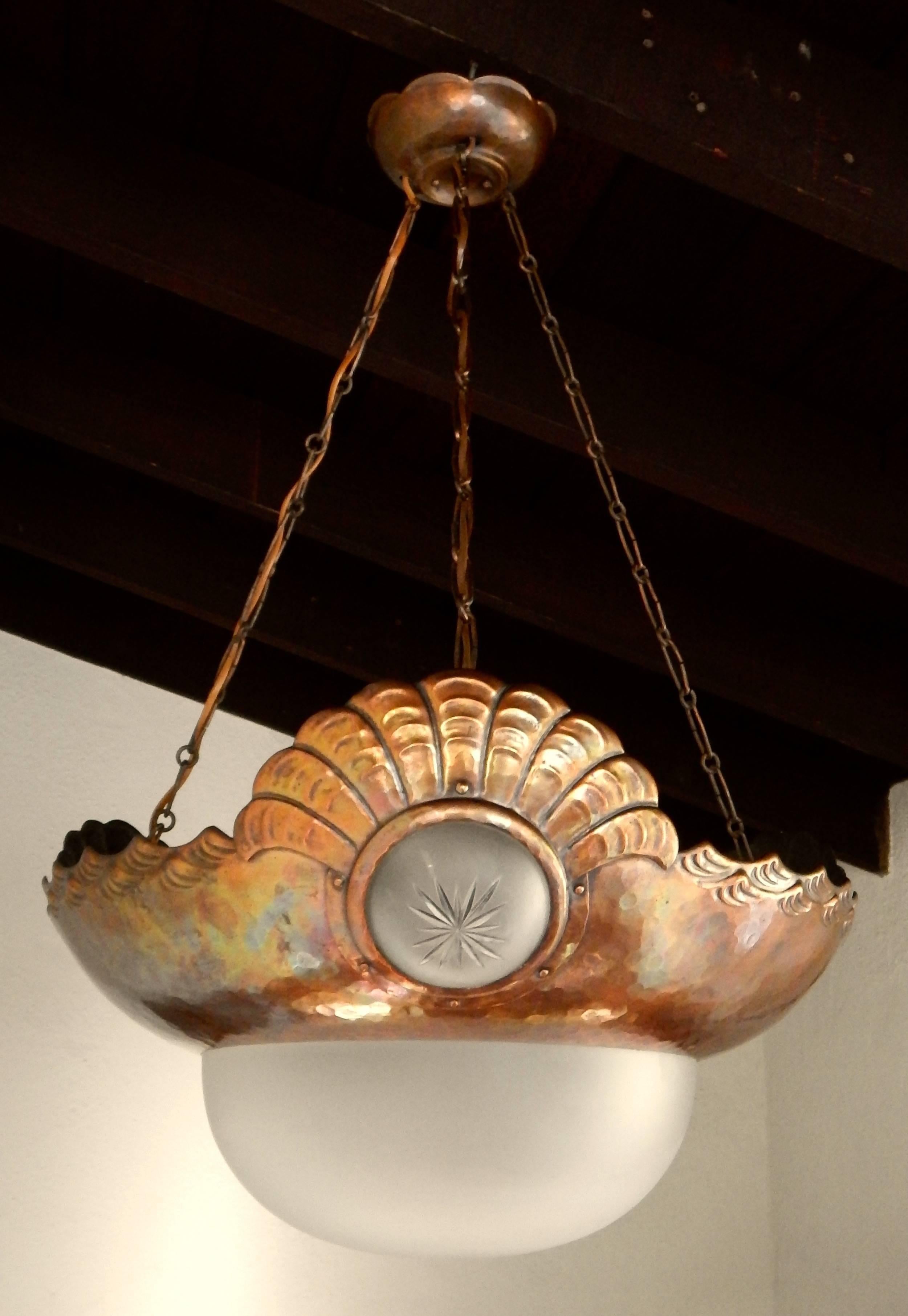 Swedish Arts & Crafts/Jugendstil hanging light fixture in hand-hammered copper. Motifs of seashell and waves. All original frosted glass. Freshly rewired with four receptacles for bulbs, Sweden, circa 1900-1910. Contact us with any questions.