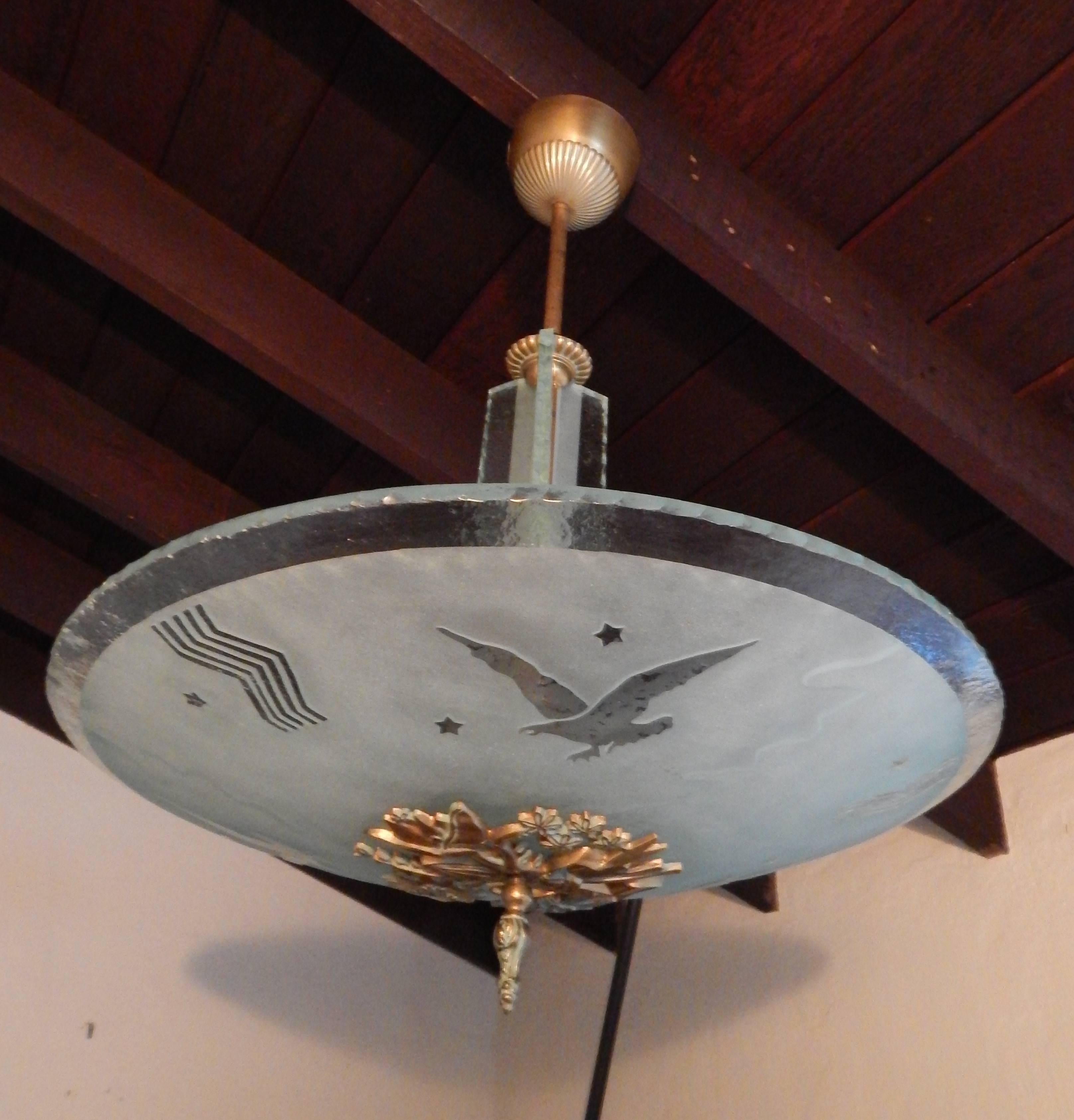 Swedish Art Deco acid etched glass hanging fixture. There are eagles and clouds etched into the bowl. Glass ends are all hammered. The art glass continues up the stem of the fixture. All metal work is bronze. In excellent antique condition and