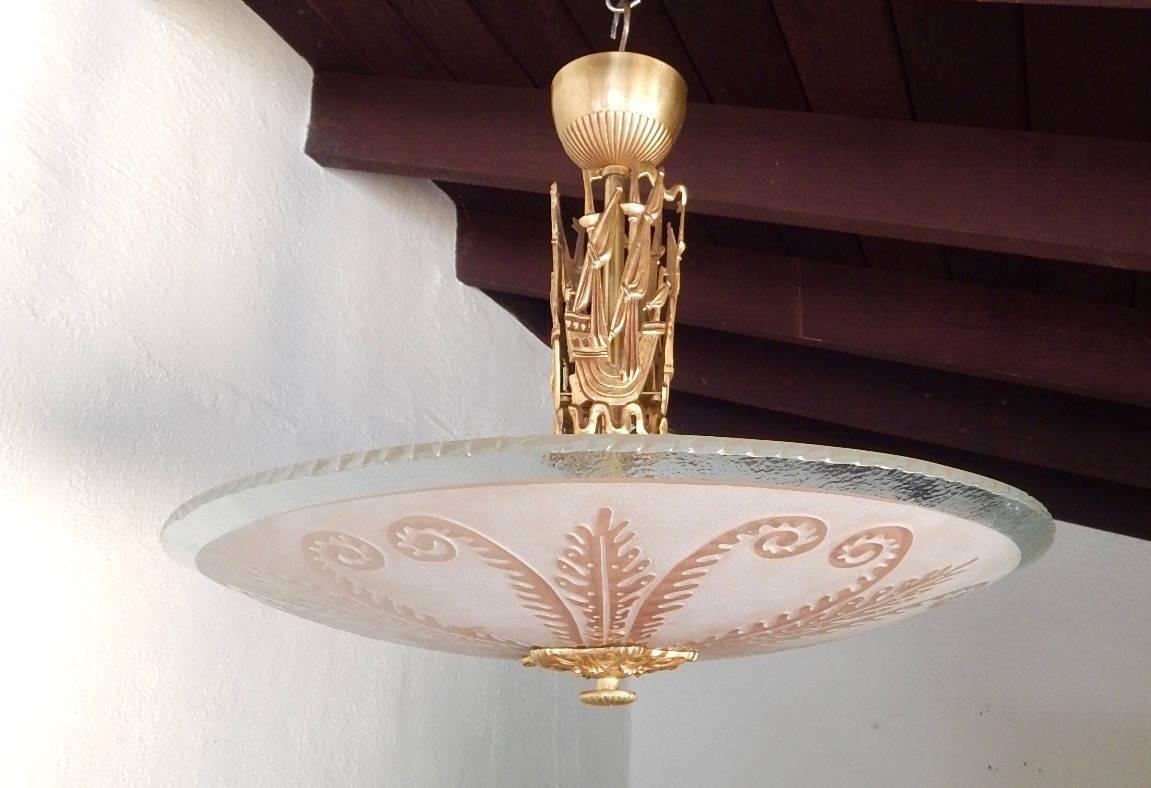 Swedish etched and sandblasted glass hanging fixture by Orrefors. The shade is rose colored and arm is gilded with figurative sailing ships. Some scratches on the original metal canopy. Otherwise in excellent original condition, Sweden, circa 1950.
