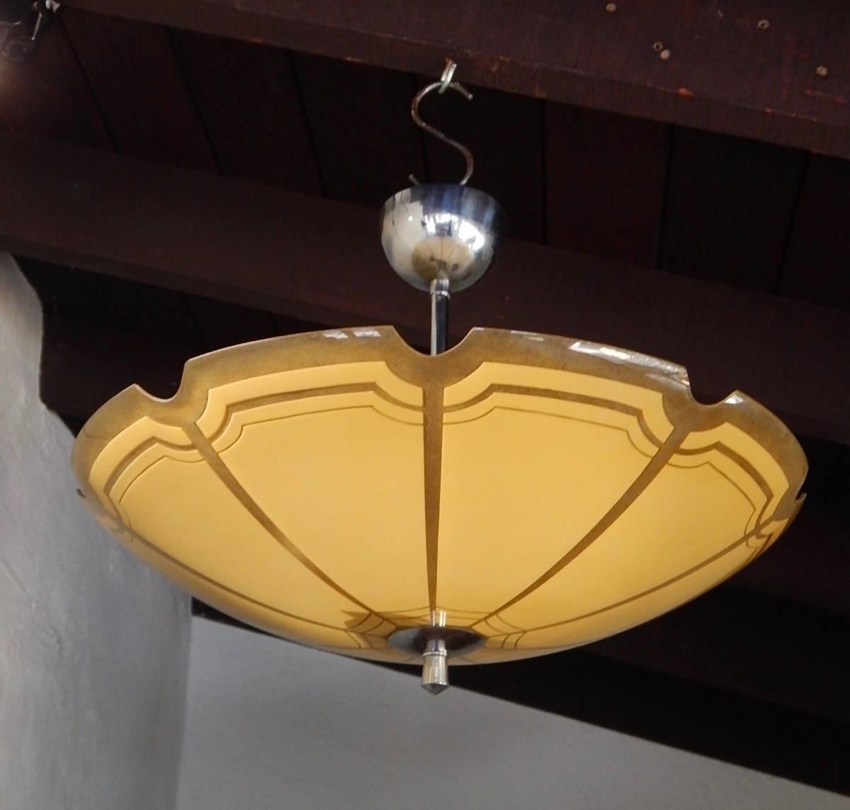Swedish Mid-Century Modern hanging fixture with glass bowl, circa 1950. Bowl glows a very attractive creamy yellow color. All original with bowl in excellent condition. Two standard base bulb receptacles. Price includes complete rewiring.