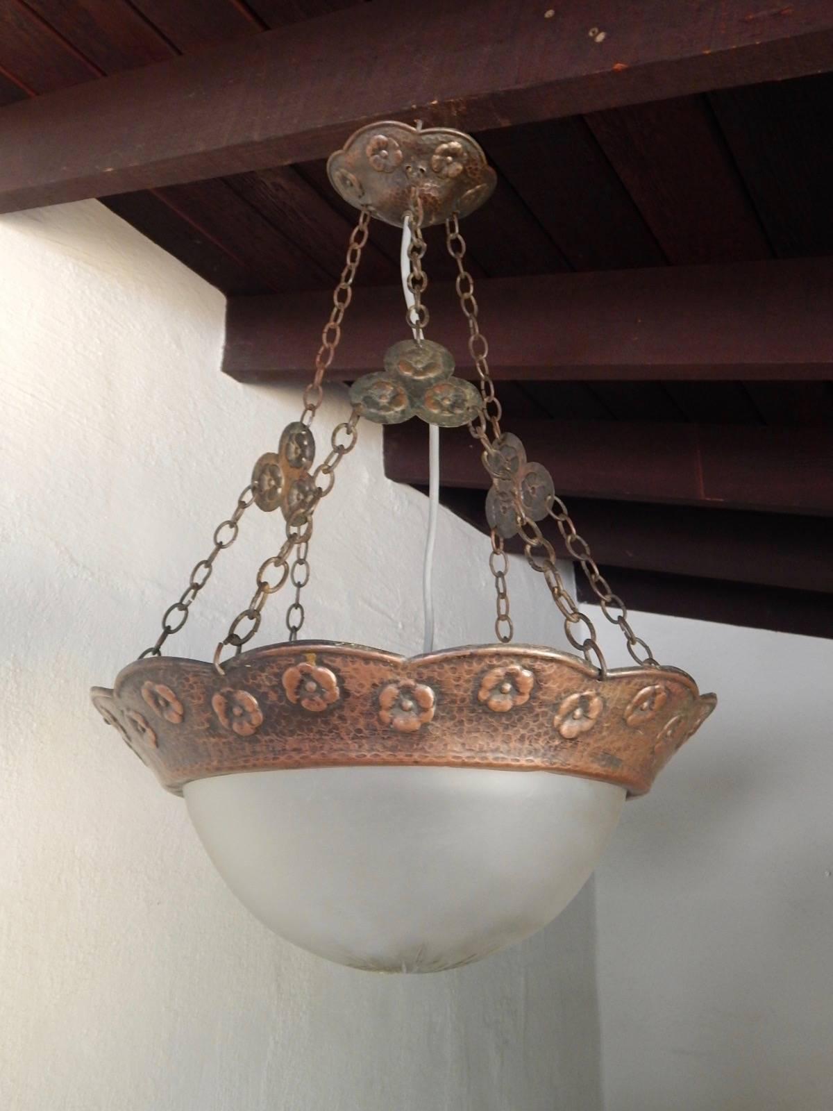 Swedish Arts & Crafts are hammered copper hanging light fixture, circa 1910. With One standard base bulb receptacle that hangs into original glass bowl. With hammered floral motifs. Price includes rewiring. Contact is with any questions.