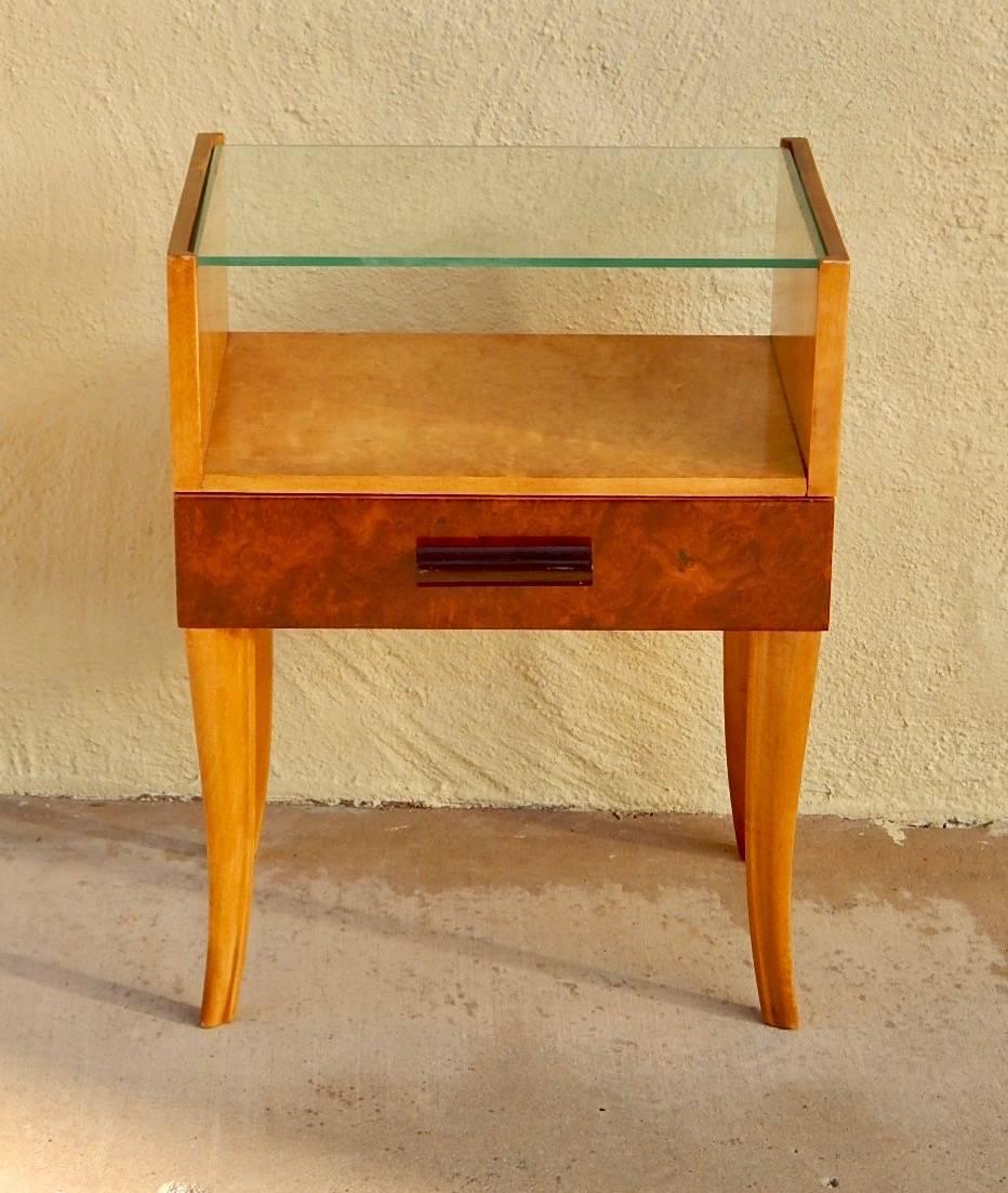 Swedish moderne side table rendered in golden flame birch wood. With one drawer fronted in carpathian elm with stained birch wood pull. Restored and in impeccable. With new glass top. Sweden circa 1940.