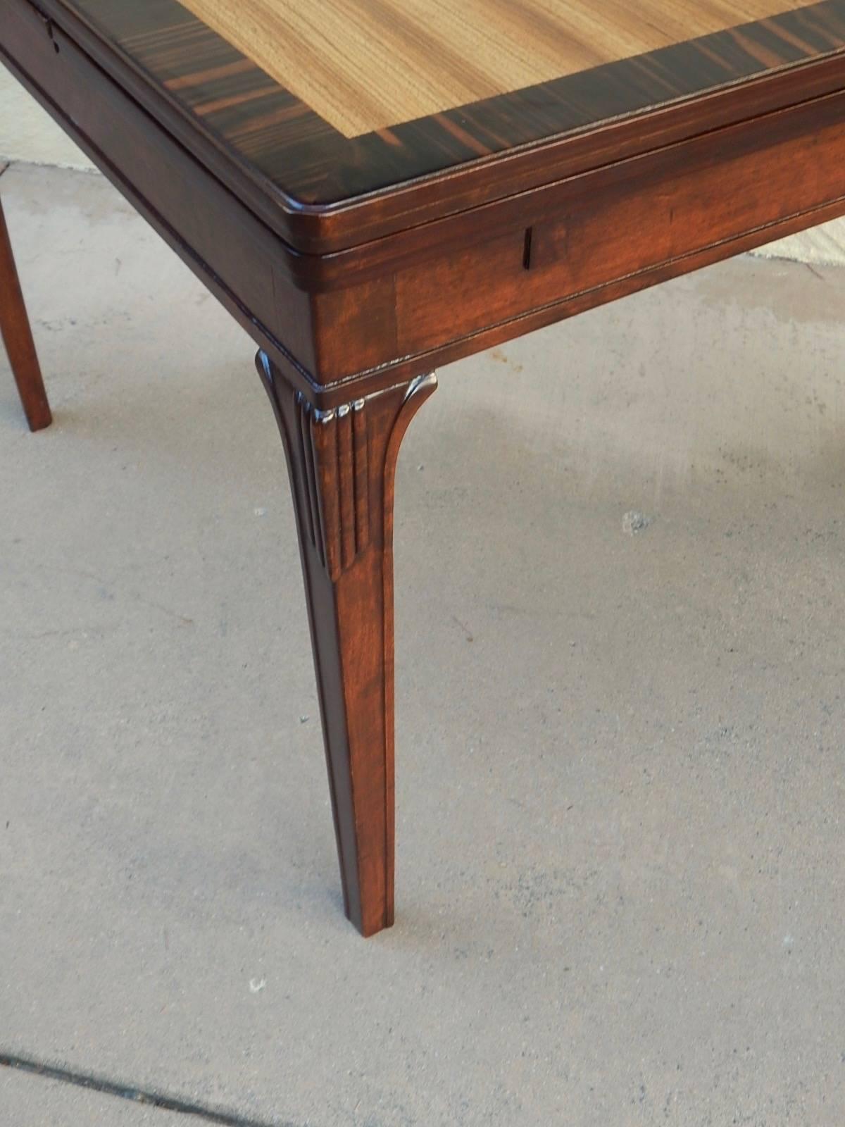 Swedish Art Deco extendible side table by Eric Chambert, circa 1930. Rendered in birch wood and zebrino with parquetry top in elm. There are two concealed leaves which extend the top to a total of 57 inches. This table has just been impeccably