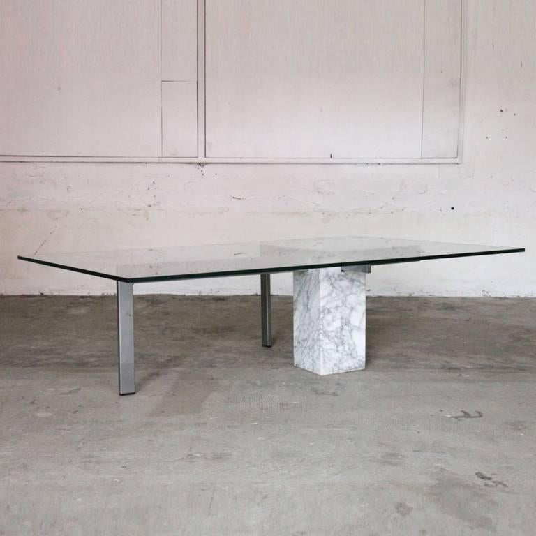 Italian vintage glass coffee table. Italian modern item with a delicate impression by combination of materials of glass, stone and steel, with a cool impression by the whole modern design.