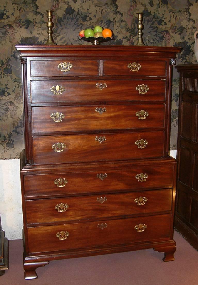 A small George II period solid mahogany chest on chest dating from circa 1760. The top with moulded cornice above two short and three long oak lined drawers with brass handles and escutcheons flanked by quarter reeded columns with corninthian