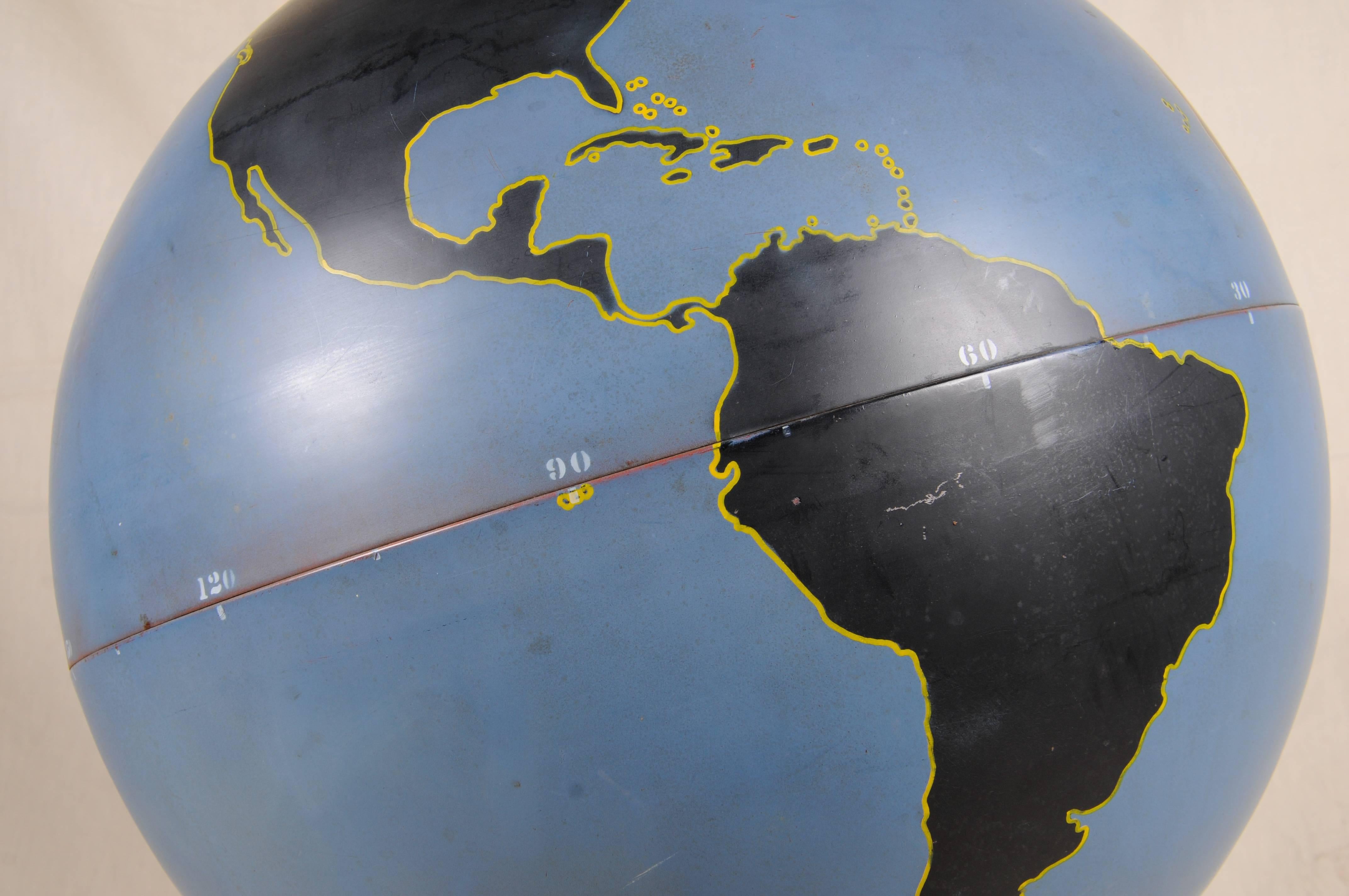 1940s Denoyer-Geppert military aviation teaching globe.
Large steel orb of two connected halves. Land masses in black with yellow outlines; oceans in a deep blue (appropriately). 
Signed with metal tag on the column.

Supported by precision