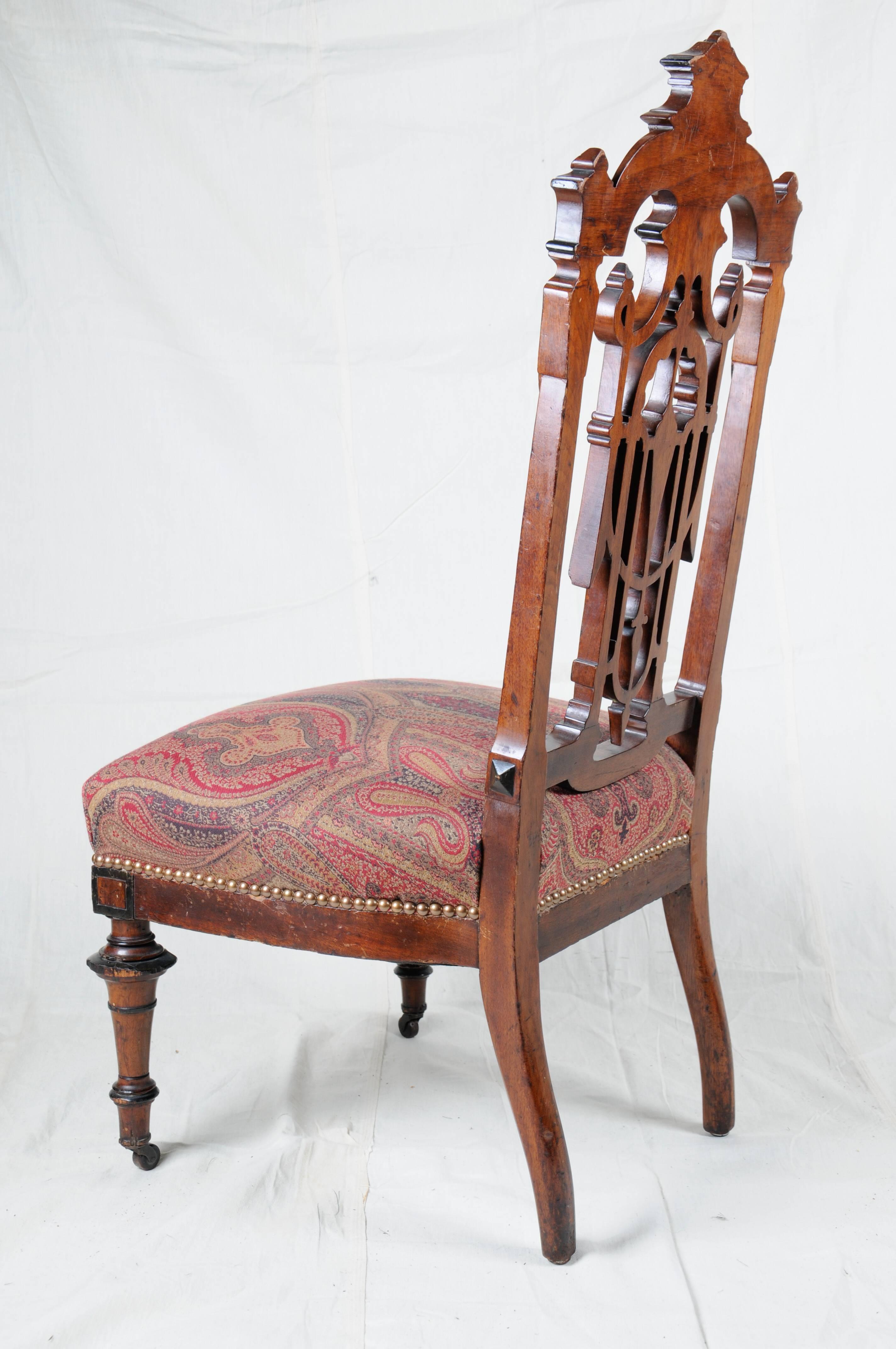 Aesthetic period chair, circa 1880.
Purchased in New Orleans the 1980s.
It has original casters on front legs, the upholstery finished off with brass nailheads. Hand tided springs. The chair has ebonized accents.

Size: 40.25