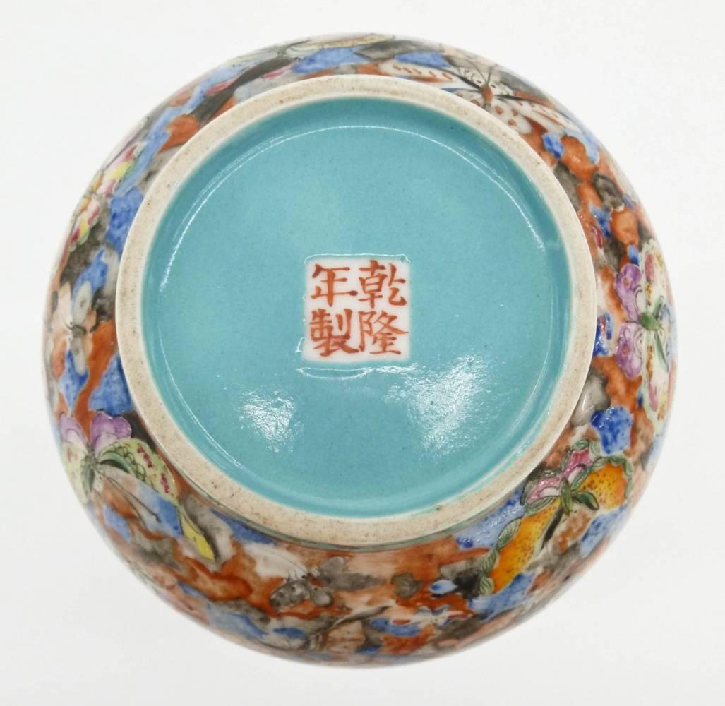 Chinese republic thousand butterfly famille rose porcelain bottle vase 8.5” x 4”.
Exterior is covered with polychrome butterfly decoration with turquoise blue interior. Bottom bears a four character red enameled Qianlong commemorative mark against