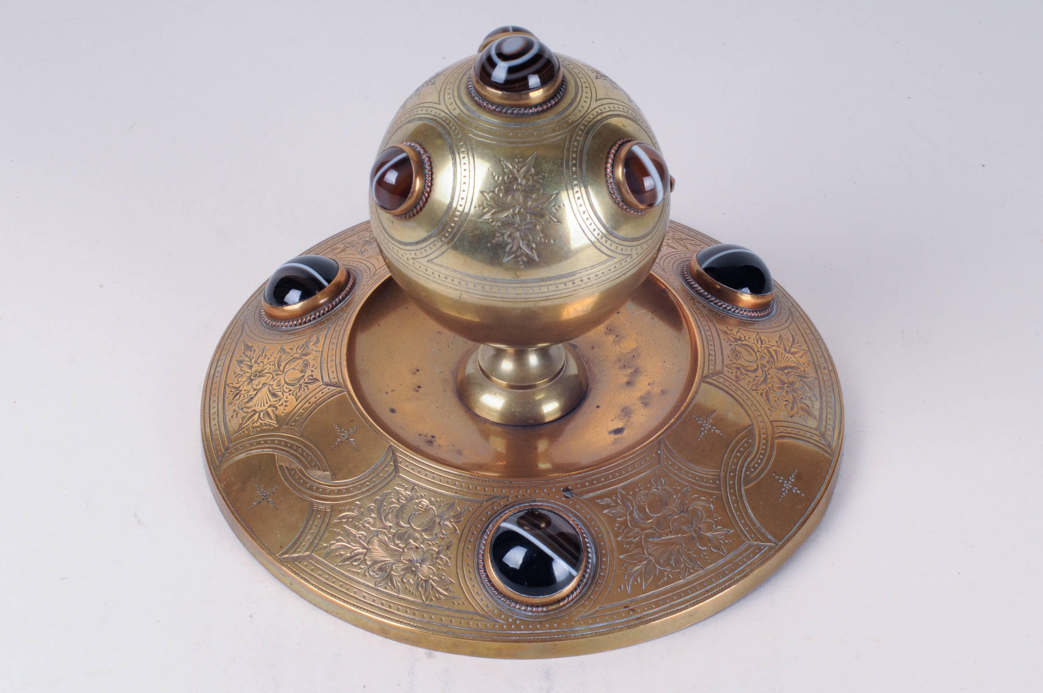 Brass inkwell with tiger-eye cabochons.
Round base with domed and hinged cover. Hand chasing on all surfaces,
French,
1819-1911.
Size: 5.5" H x 6.5" D.