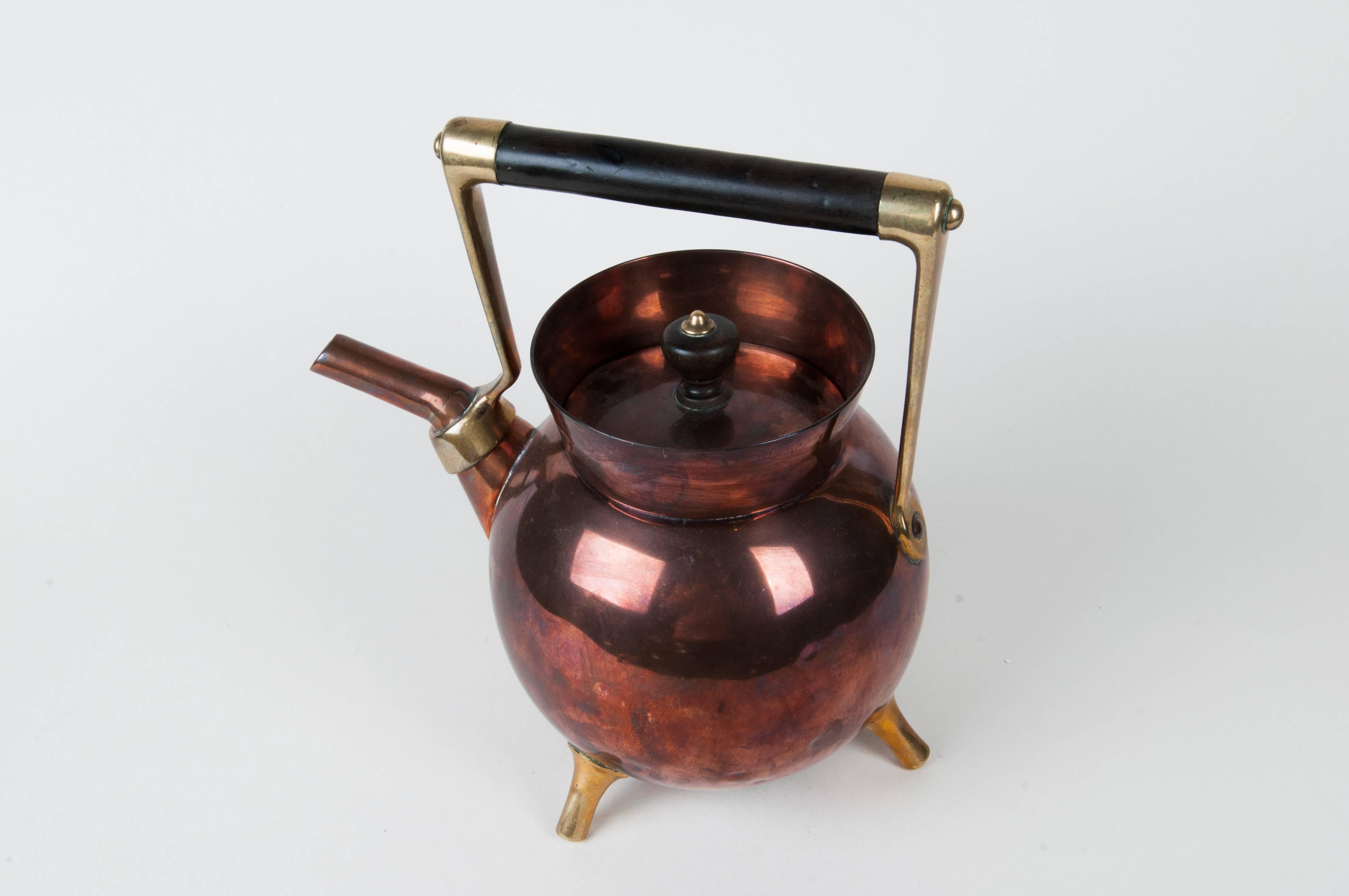 Christopher dresser teapot
Made by Benham & Fround, London
Copper and brass, ebony handle
Marker's mark,
circa 1885
Size: 9.3" H.