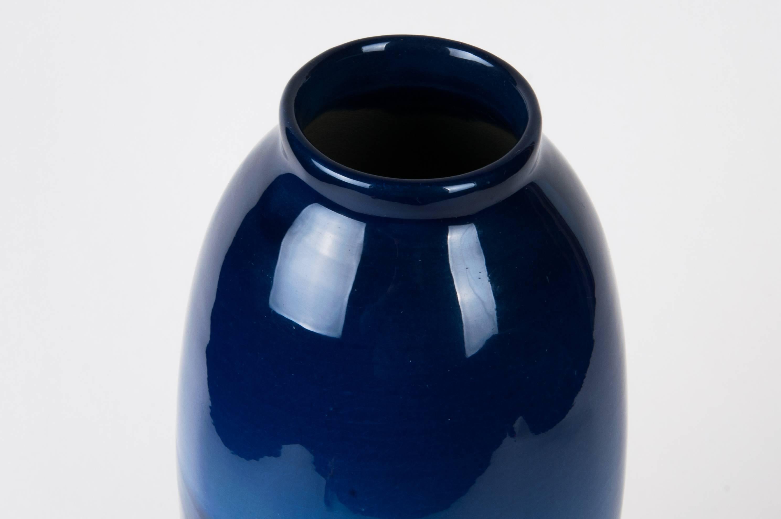 Samuel A. Weller blue louwelsa vase
High gloss background, hand decorated flowers
Impressed Weller mark
Rare piece
Size: 12" H.