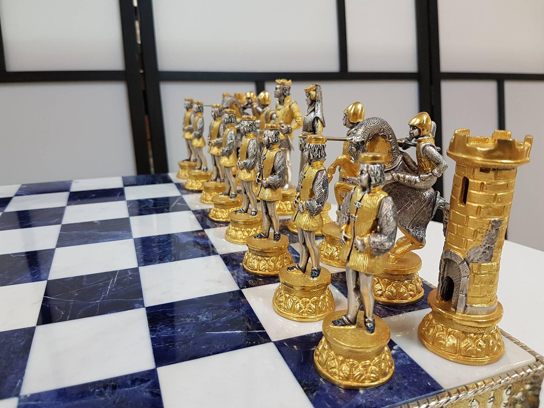 Sterling silver bi-color chessboard and chess game in medieval style.
The chessboard is in molten silver with blue lapis and white color marble on four horses
Total 10,000 grams.