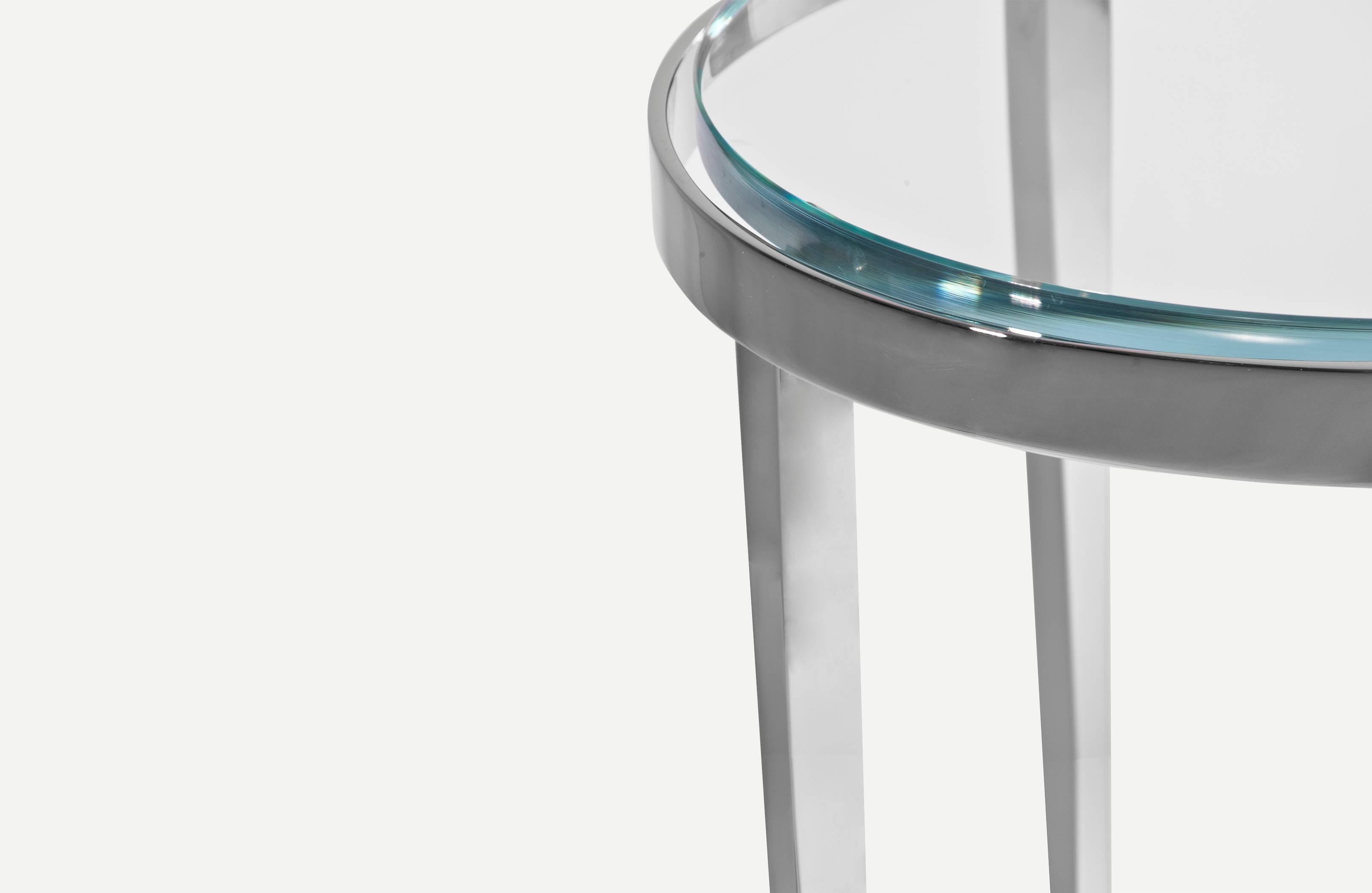 Ainslie, named after Christopher Gentner's favorite street in Chicago, the table was inspired by the poise of a flower stem, having the taper and balance as the focus of the table. Crafted by hand, it is nickel-plated steel has a ¾” thick glass top