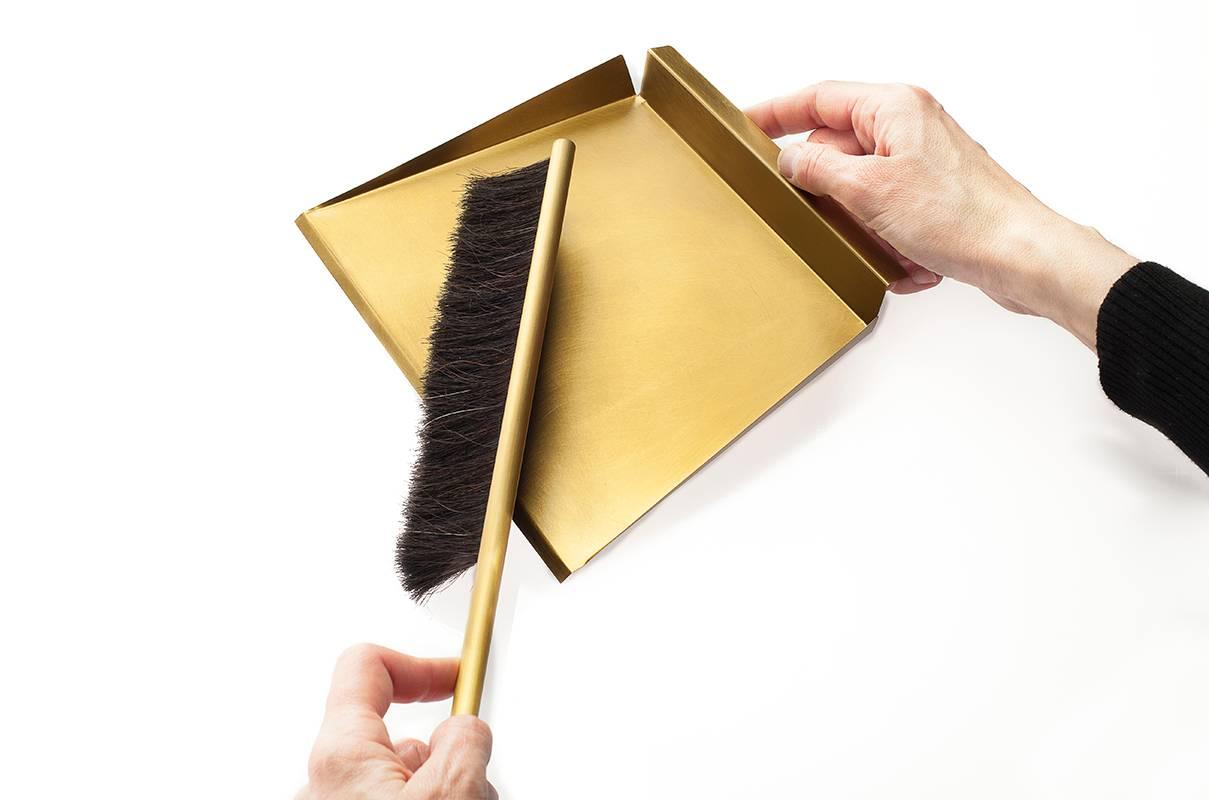 gold dustpan and brush