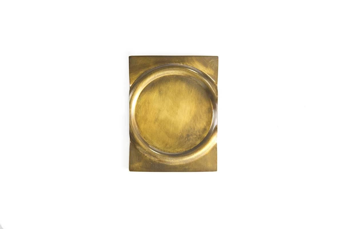 Hand-formed from a sheet of brass, emphasizing the material’s pliable characteristics expressed through the process of production, each piece is then tarnished or darkened giving it depth of finish. The coasters are both functional and a piece