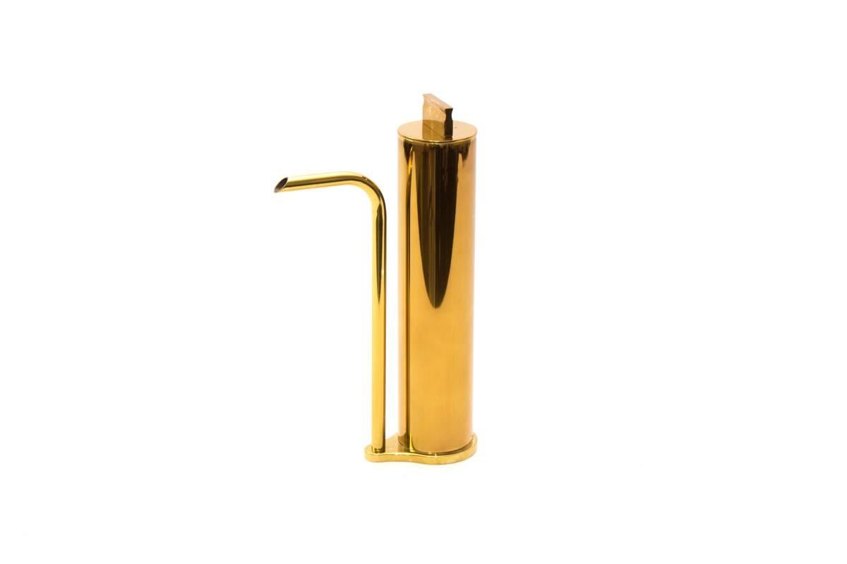 Made of brass and hand tarnished, the oil seems to magically move from the container to the spout without the two being connected. This piece, with it visual disconnects, is all about the details that exemplify the way in which the designer’s mind