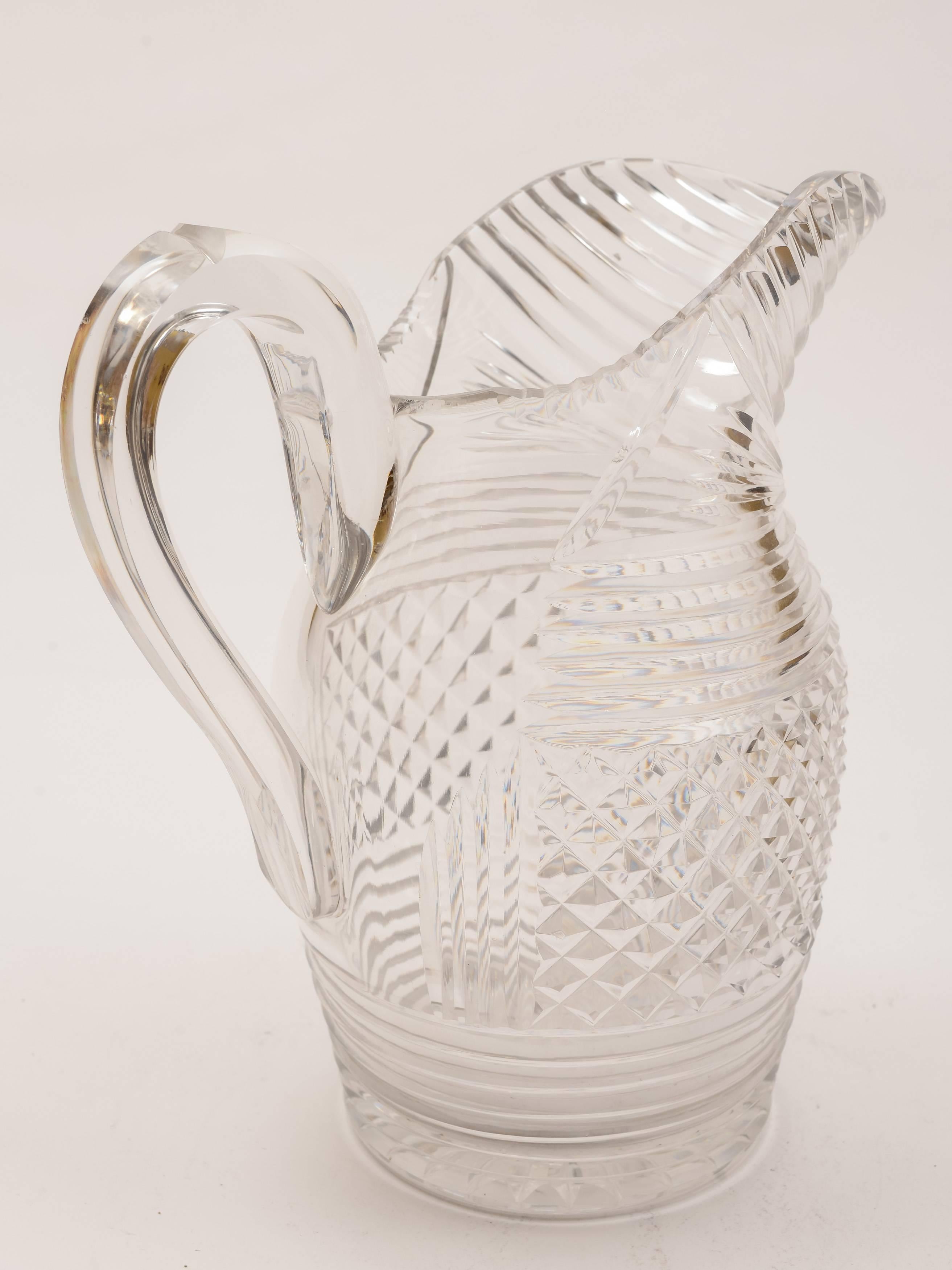 A lovely English early Victorian cut-glass water jug with strap handle and profusely cut decoration and star cut base, circa 1840.

Weight: 1379g.

   