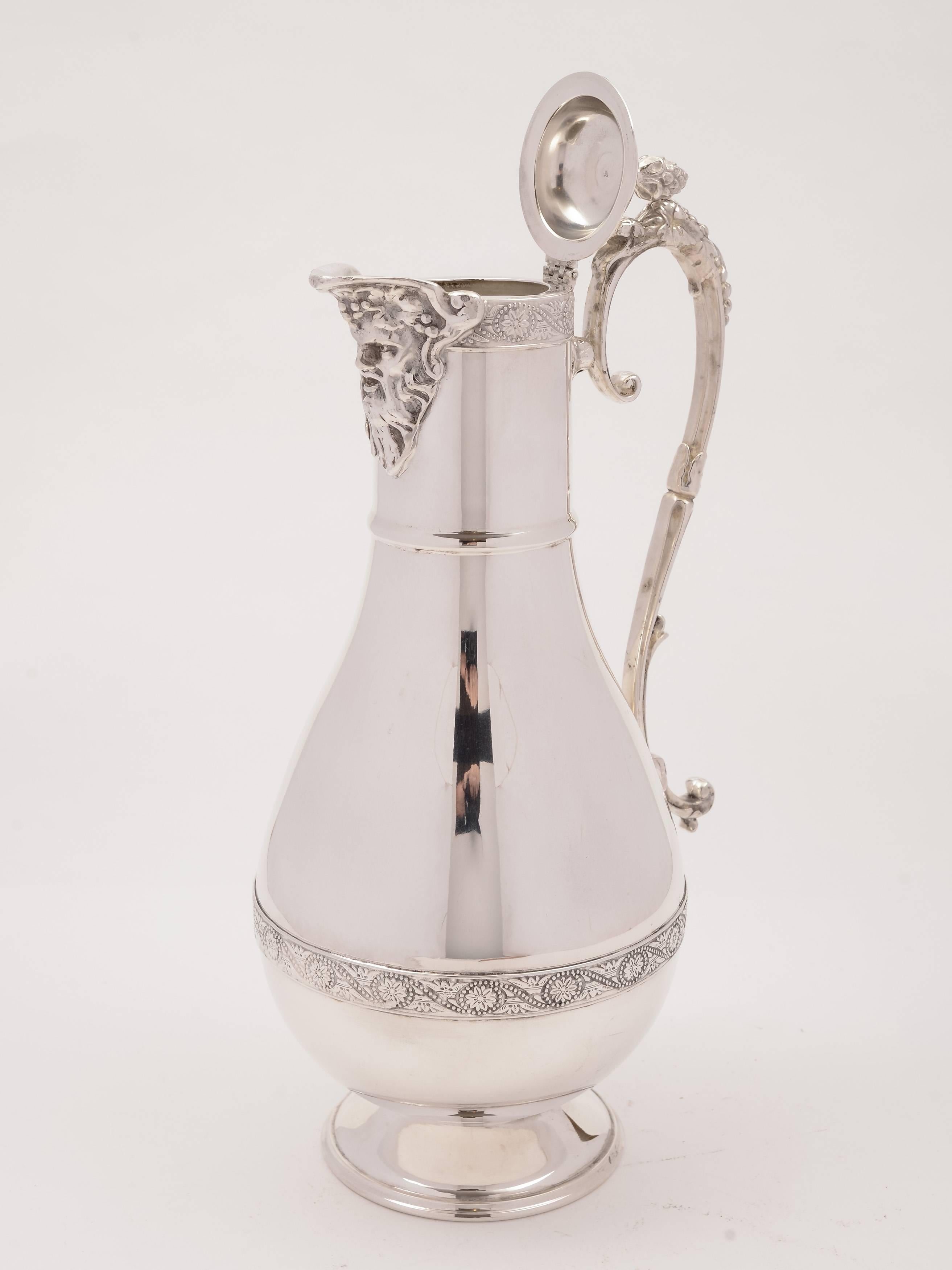 A wonderful English silver plated claret jug with embossed decoration to top and middle, ornate handle and heat of Bacchus as pouring spout, circa 1920.

Weight: 803g.
   