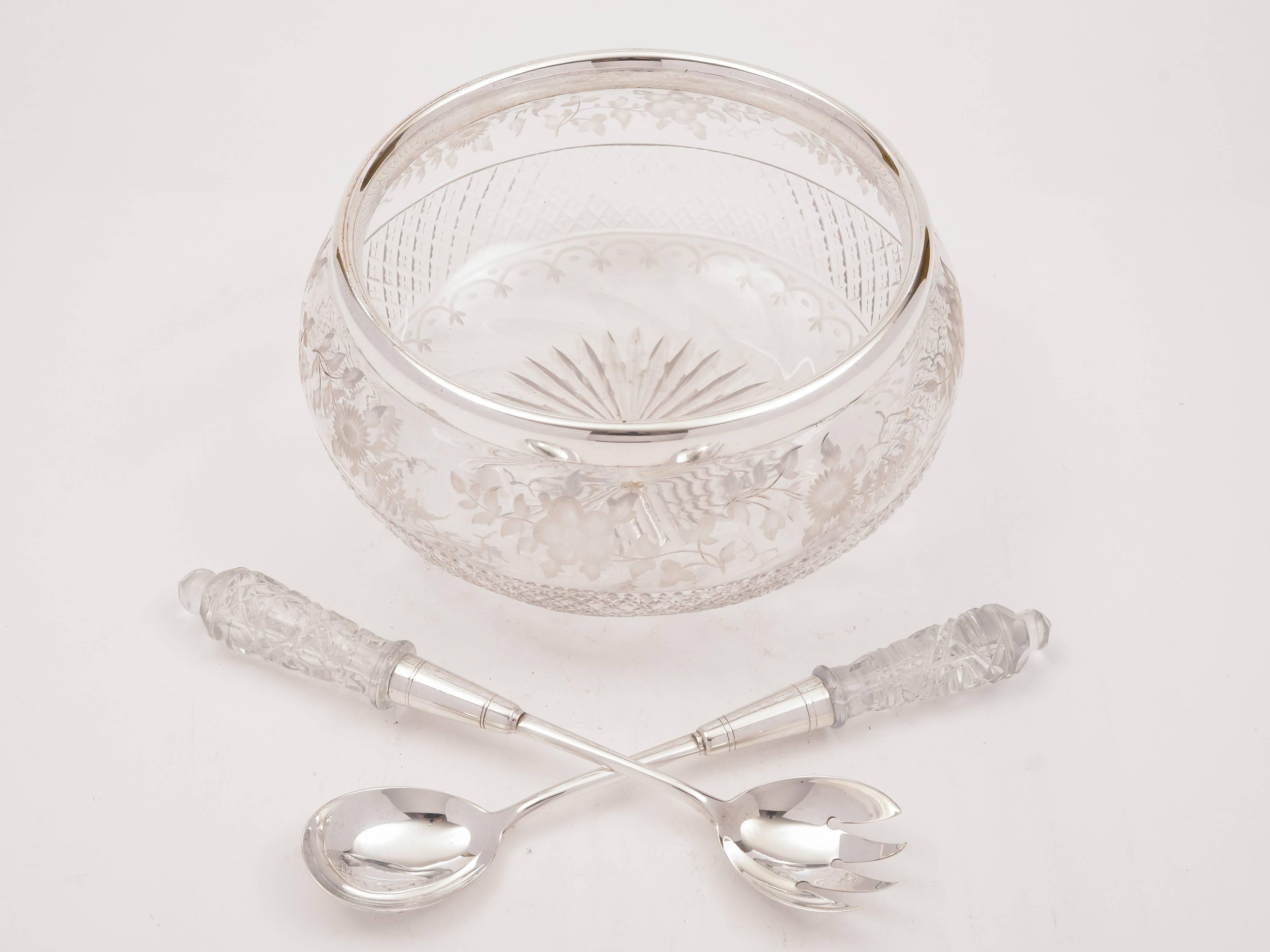A beautiful English Edwardian glass salad bowl with gorgeous etched flower and cut decoration, star cut base and silver plated rim. Comes with a pair of glass handled salad servers, circa 1905. 

Total weight: 1710g.
   