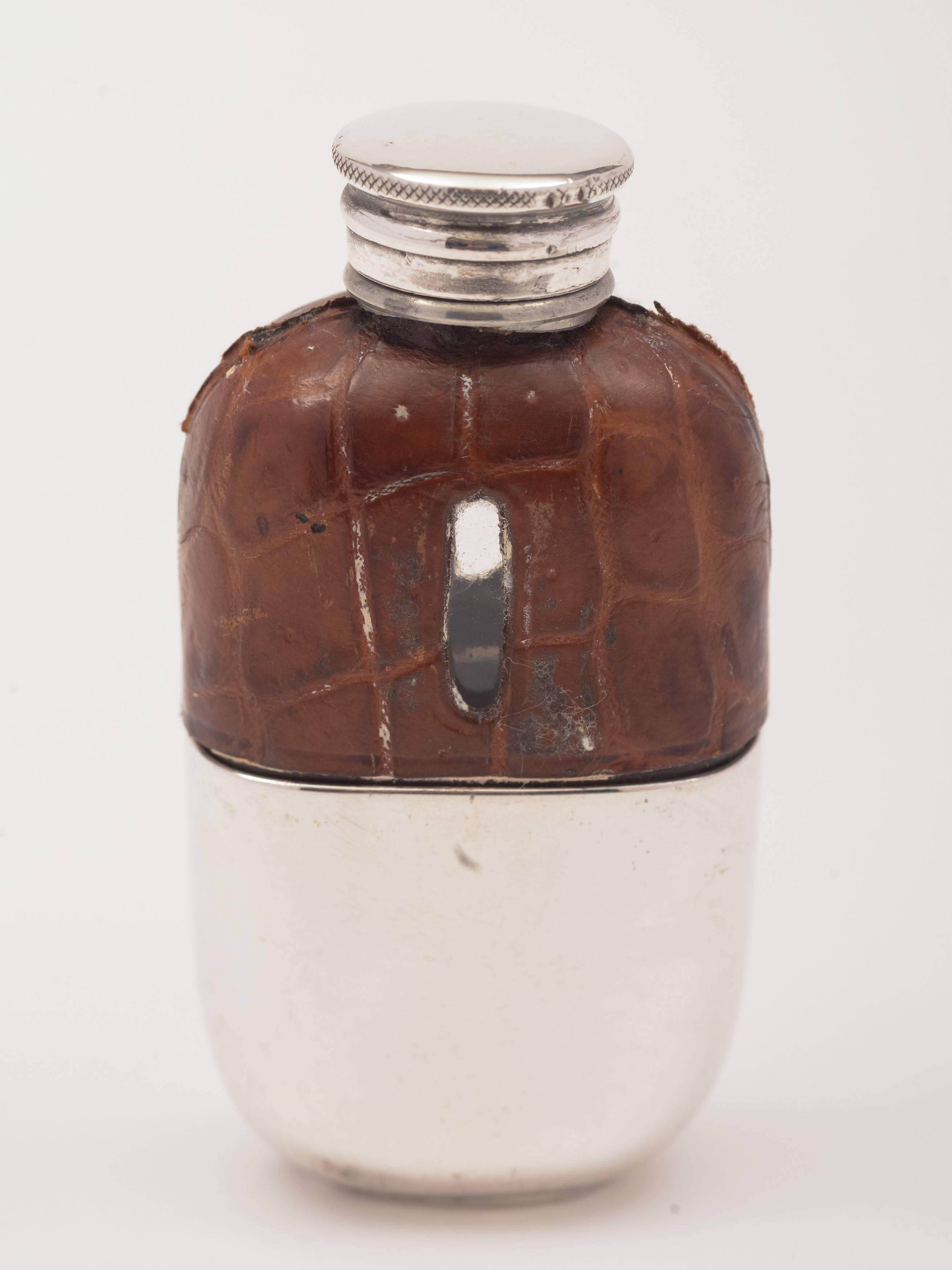 A cute little English Victorian silver plated and crocodile skin covered flask with screw-on lid and detachable cup to base, circa 1895.

Total weight: 61g

This is probably the smallest crocodile skin-covered flask we've had.