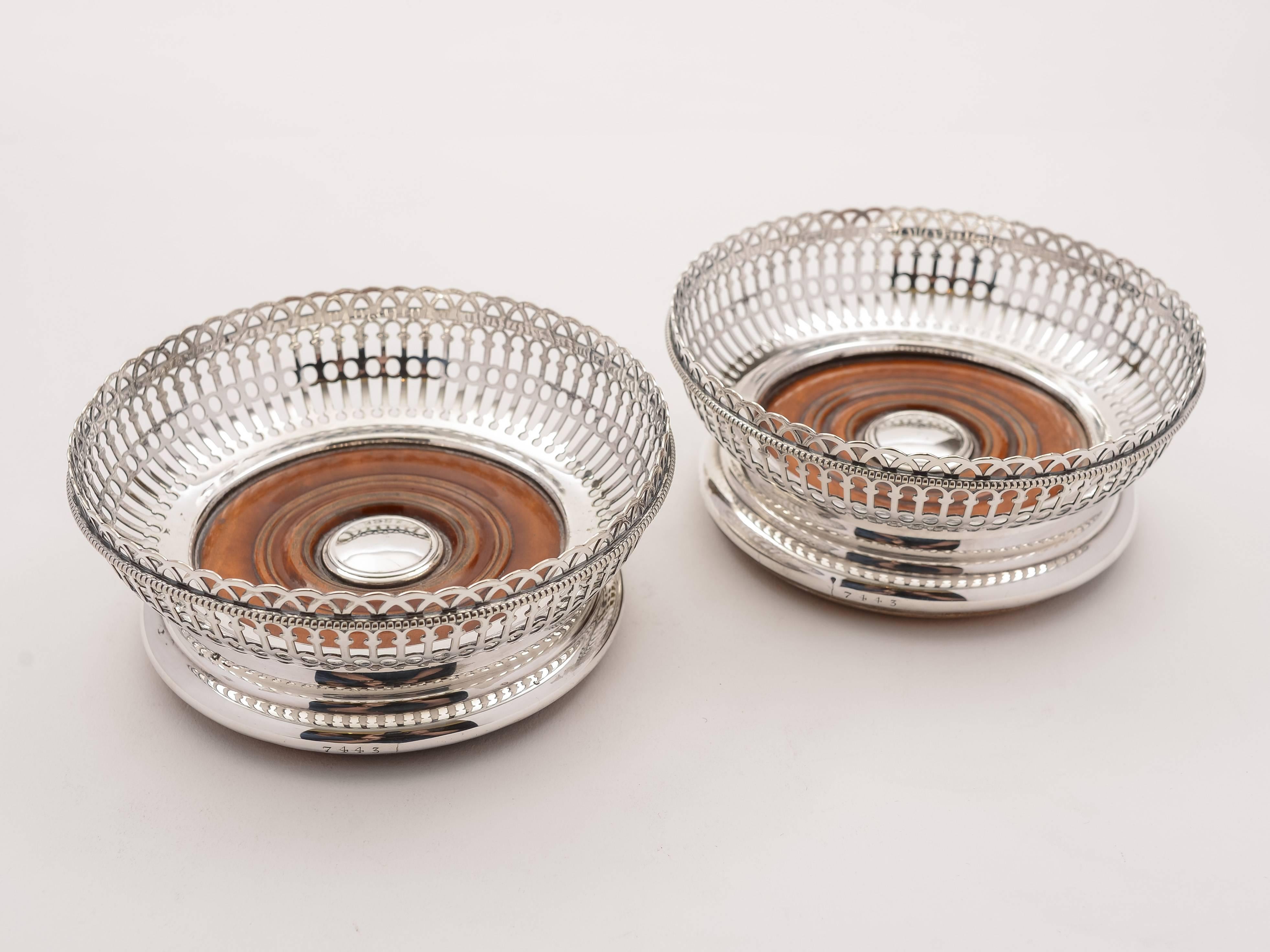 A beautiful pair of English Victorian Elkington & Co silver plated coasters with walnut bases and pierced and beaded decoration to silver plate. Has Elkington mark which dates it at 1860.

 