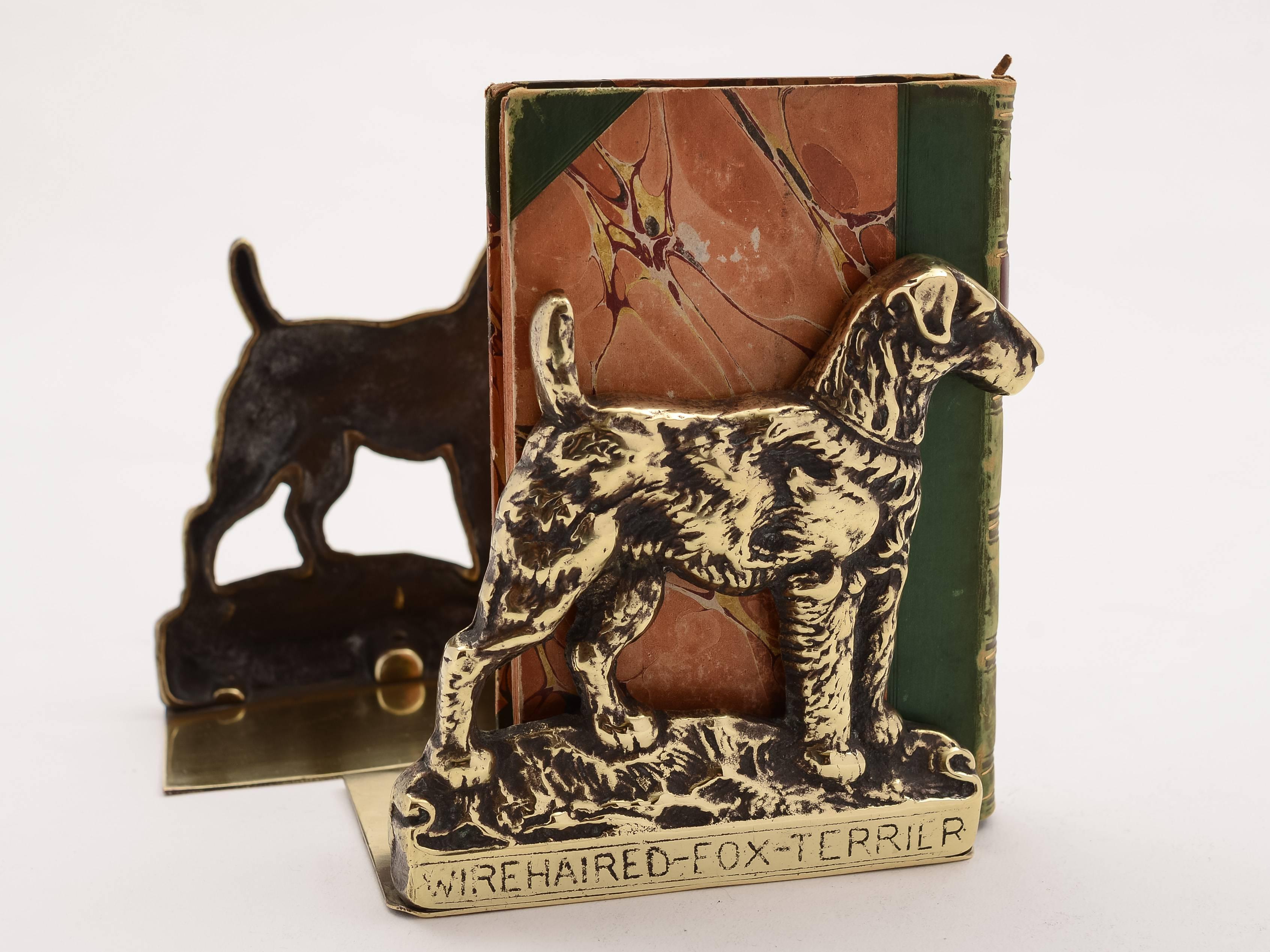 A pair of English Edwardian brass bookends, nicely modelled on wirehaired fox terrier dogs, circa 1910.

Would look good in the study or on your desk!

 