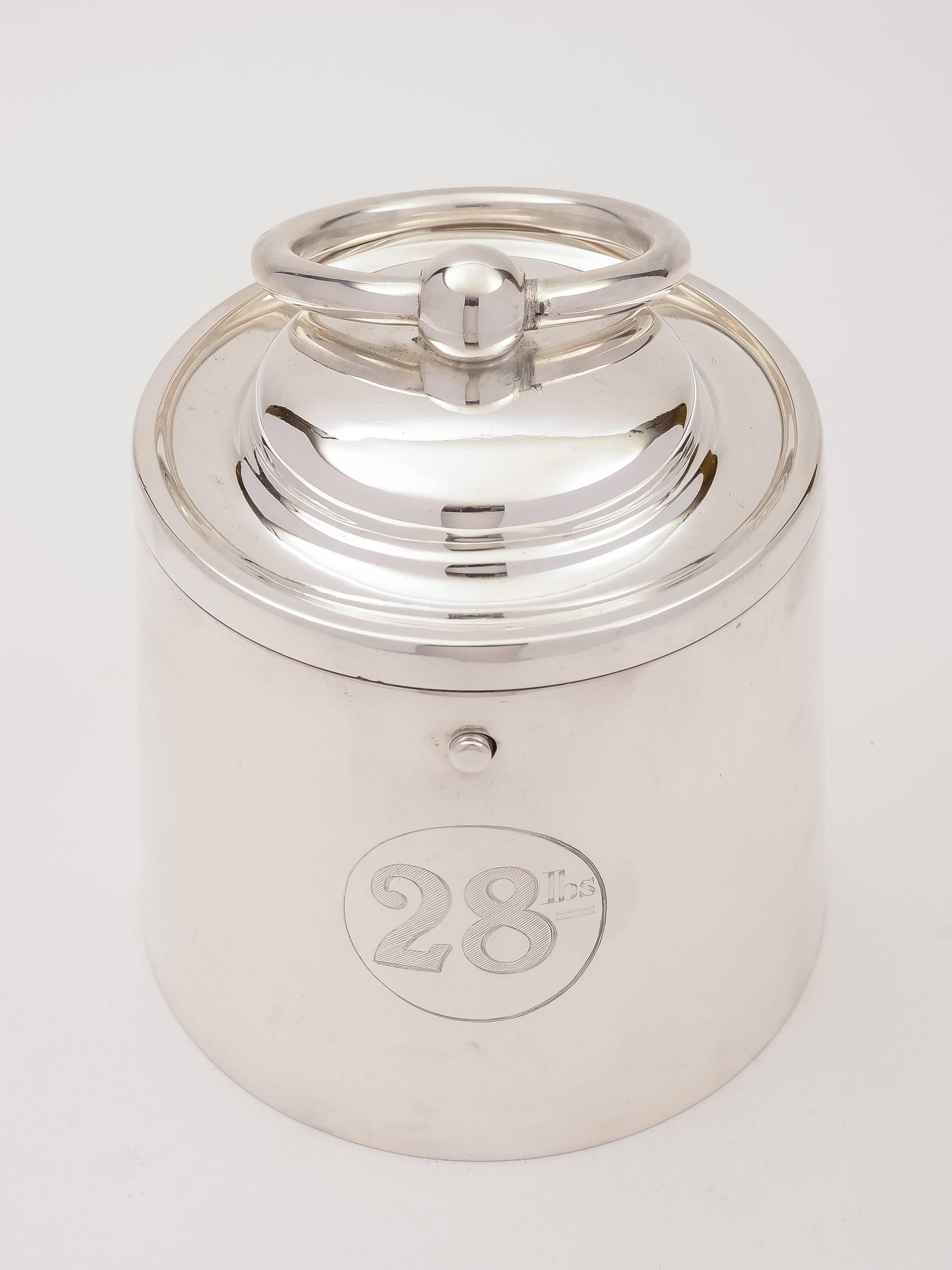 An unusual Victorian silver plated biscuit or cookie jar in the shape of a 28lb weight. There is a button to press on the front of the box which opens and locks it, allowing you to carry it with ease. It is also engraved on the front '28lb', circa