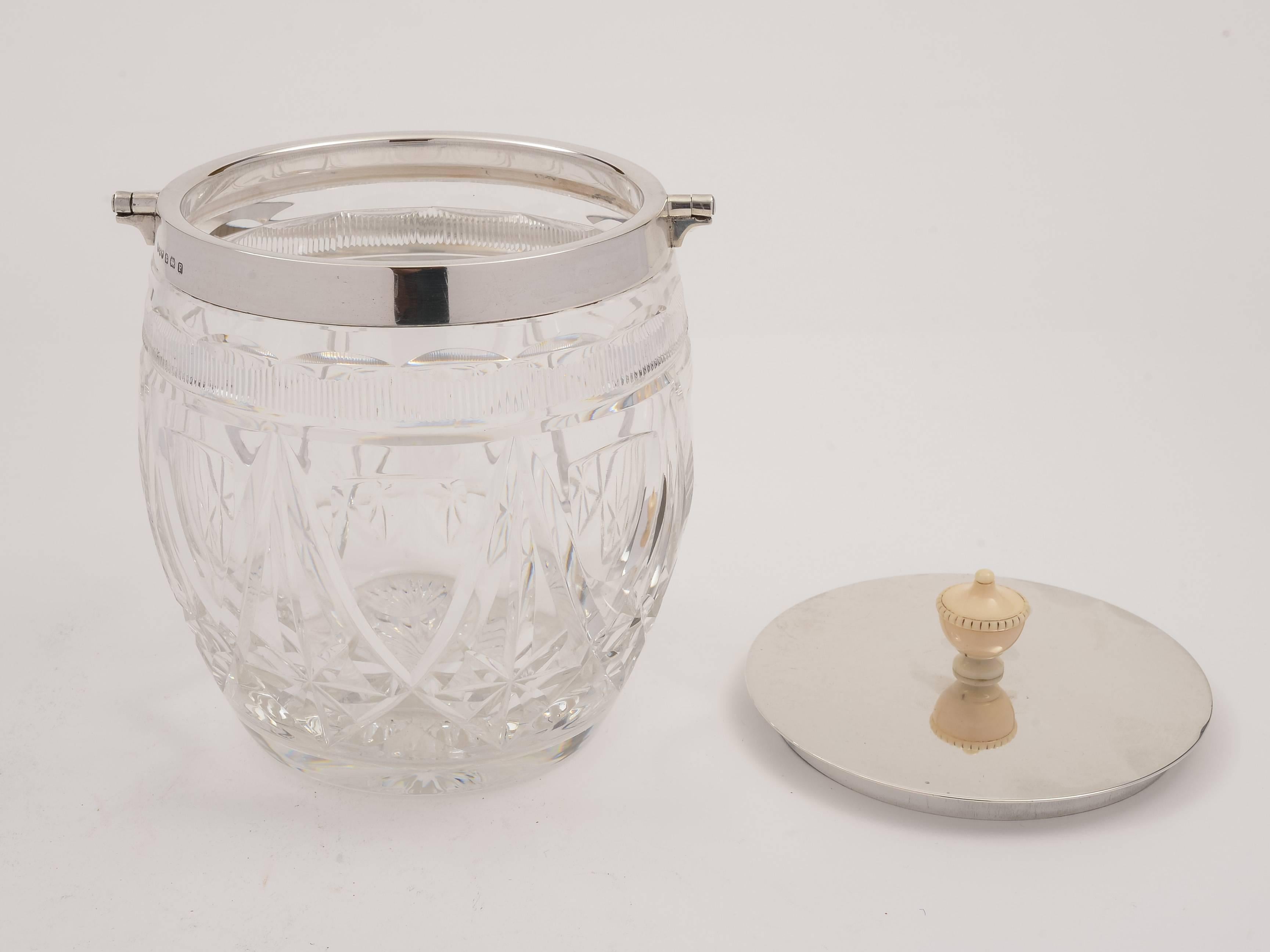 A good English silver topped cut-glass biscuit barrel with folding handle, made by Hukin & Heath and hallmarked Birmingham, 1930.

Superb quality biscuit barrel by a good maker!

