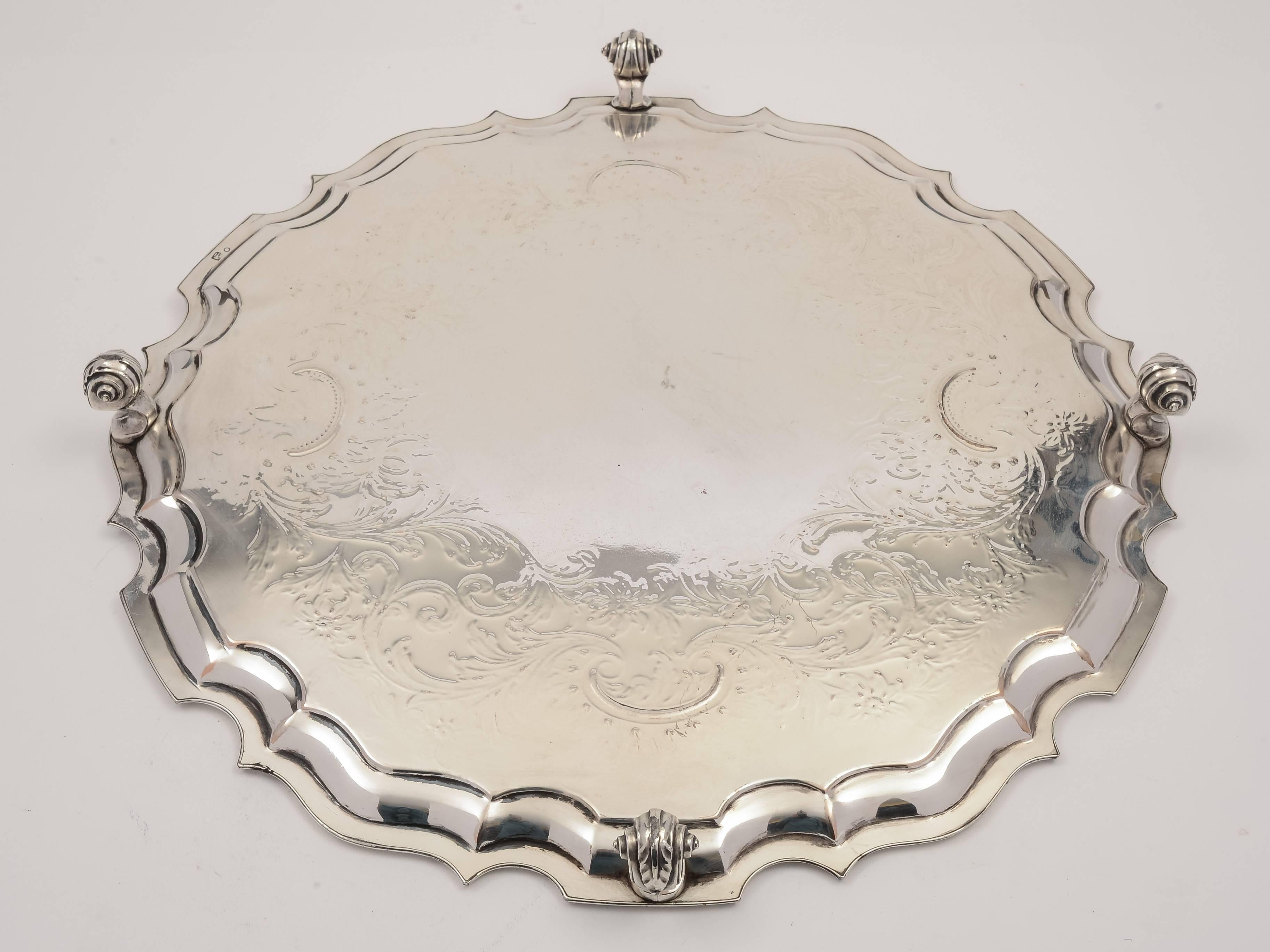 A very nice, large English Sheffield plated salver with engraved foliate design and pie crust decoration to the edge, stands on scroll feet. Has the phoenix mark for John Waterhouse and E. Hatfield & Co (1836-1846).

A beautiful period piece in