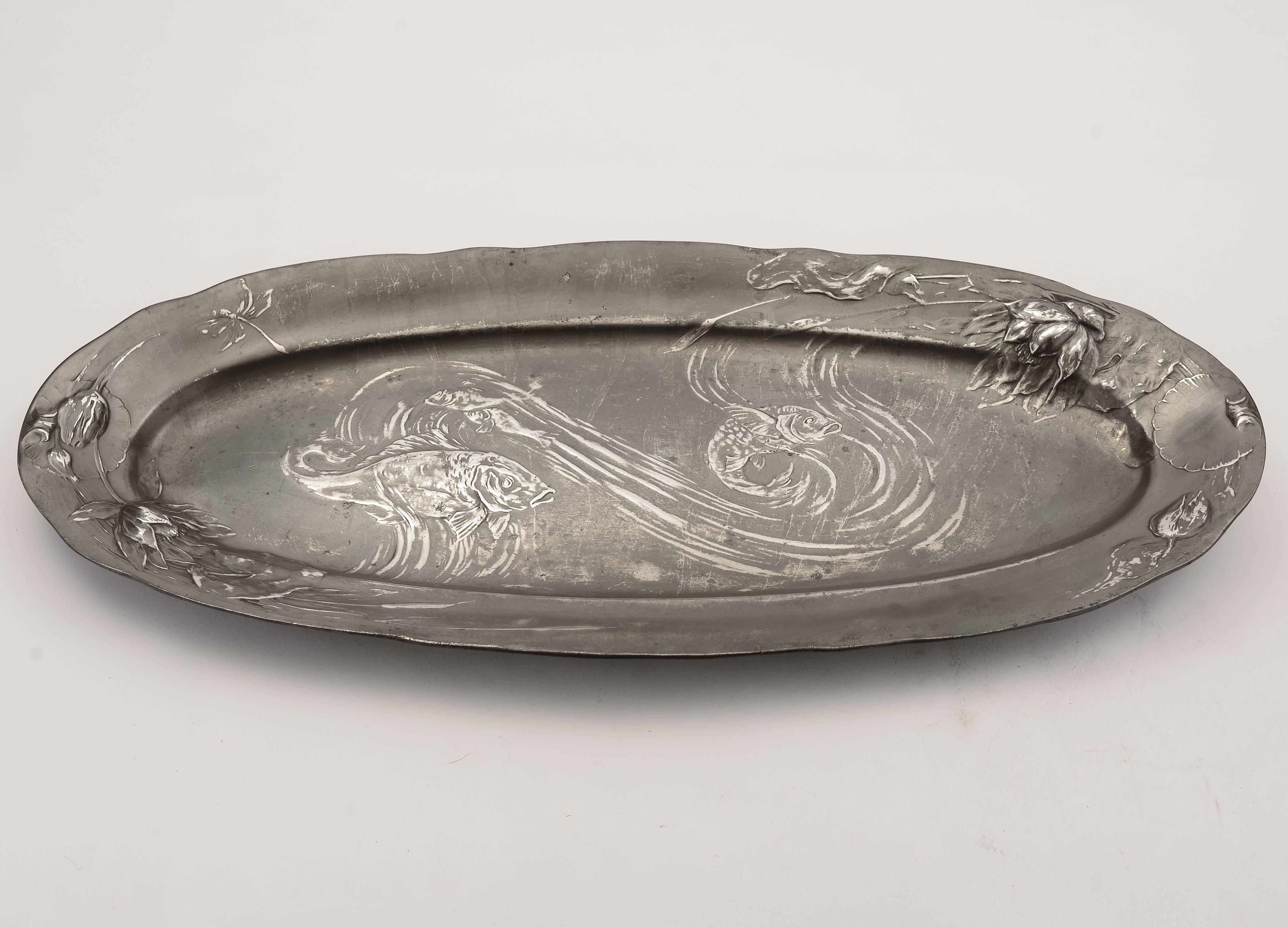 A fabulous large German Kayserzinn Art Nouveau pewter platter with embossed lily pad decoration to rim and fish swimming to the centre. Has patent number 4128, circa 1910.

Worldwide, first class, tracked and signed for delivery is included in the