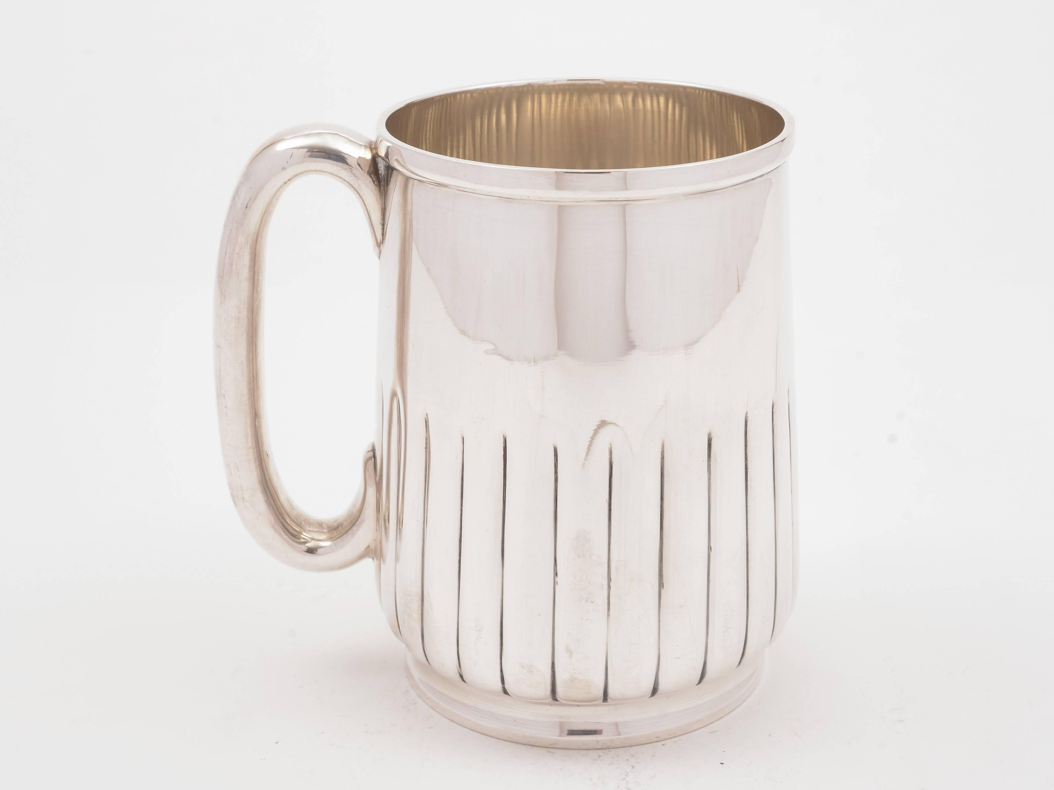 A good quality English Victorian silver plated pint tankard with fluted decoration to bottom half, circa 1890 and marked 'T.W' for the maker Thomas Wilkinson & Sons, Pelican Works, Sheffield. 

Measurements:
Height 4 1/2